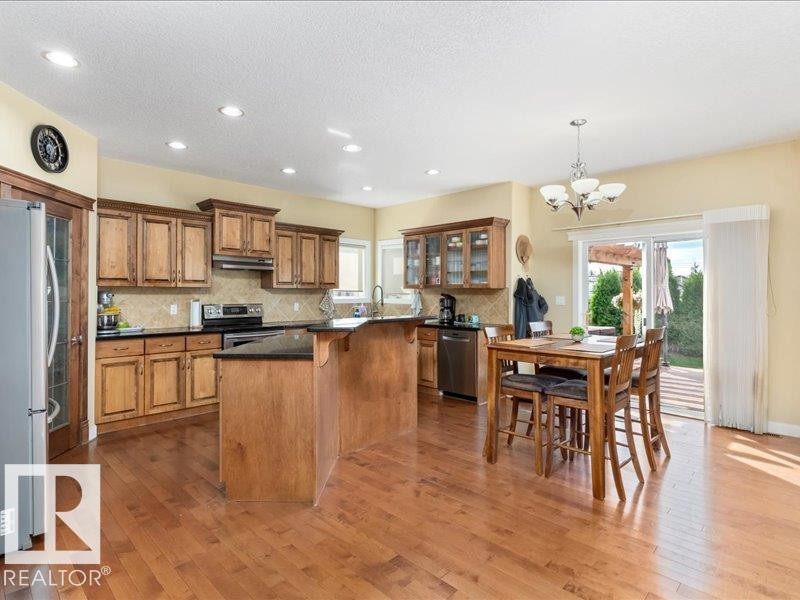 Wood-finish flooring throughout the kitchen and dining area - 496 Ravine Court, Devon, AB