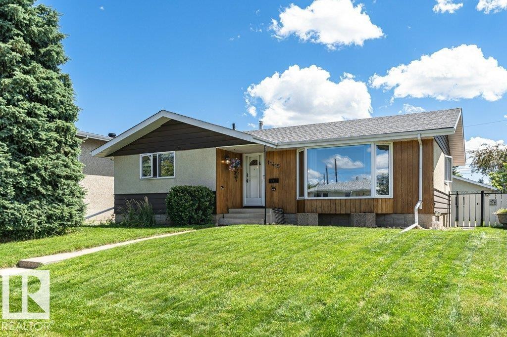 Single-story residence featuring a large front yard with a concrete walkway - 11415 56 Avenue Nw, Edmonton, AB