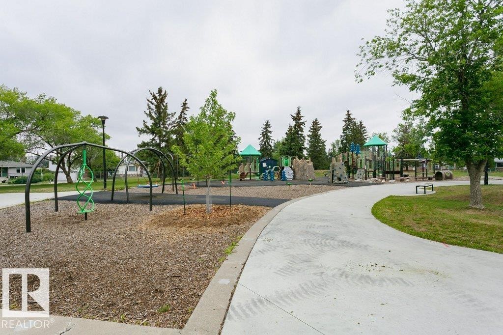 Expansive park setting featuring a multi-structure playground - 11415 56 Avenue Nw, Edmonton, AB