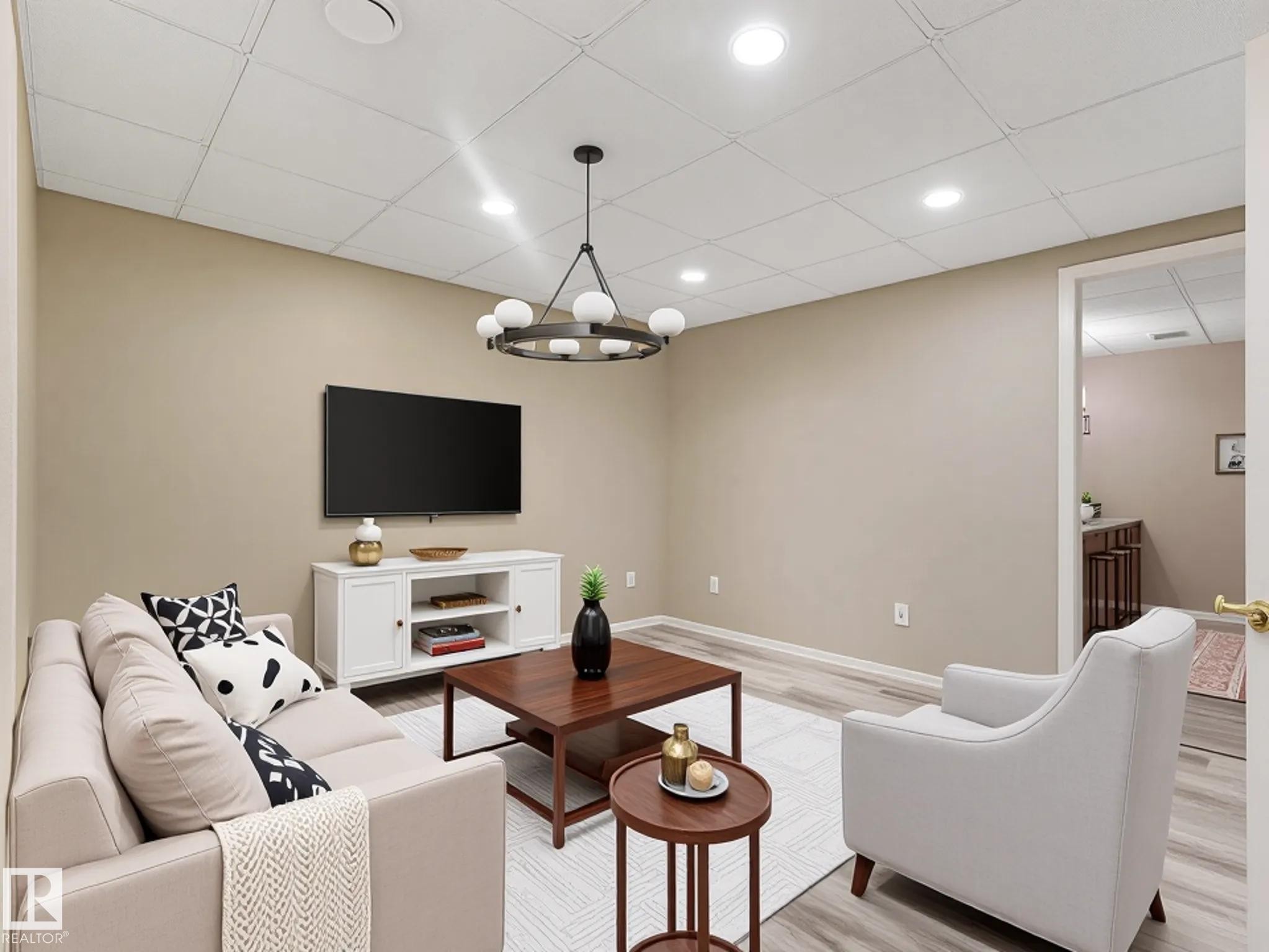 Neutral wall paint, recessed lighting, wood-finish flooring, drop ceiling, and a built-in media console - 15916 88B Avenue Nw, Edmonton, AB