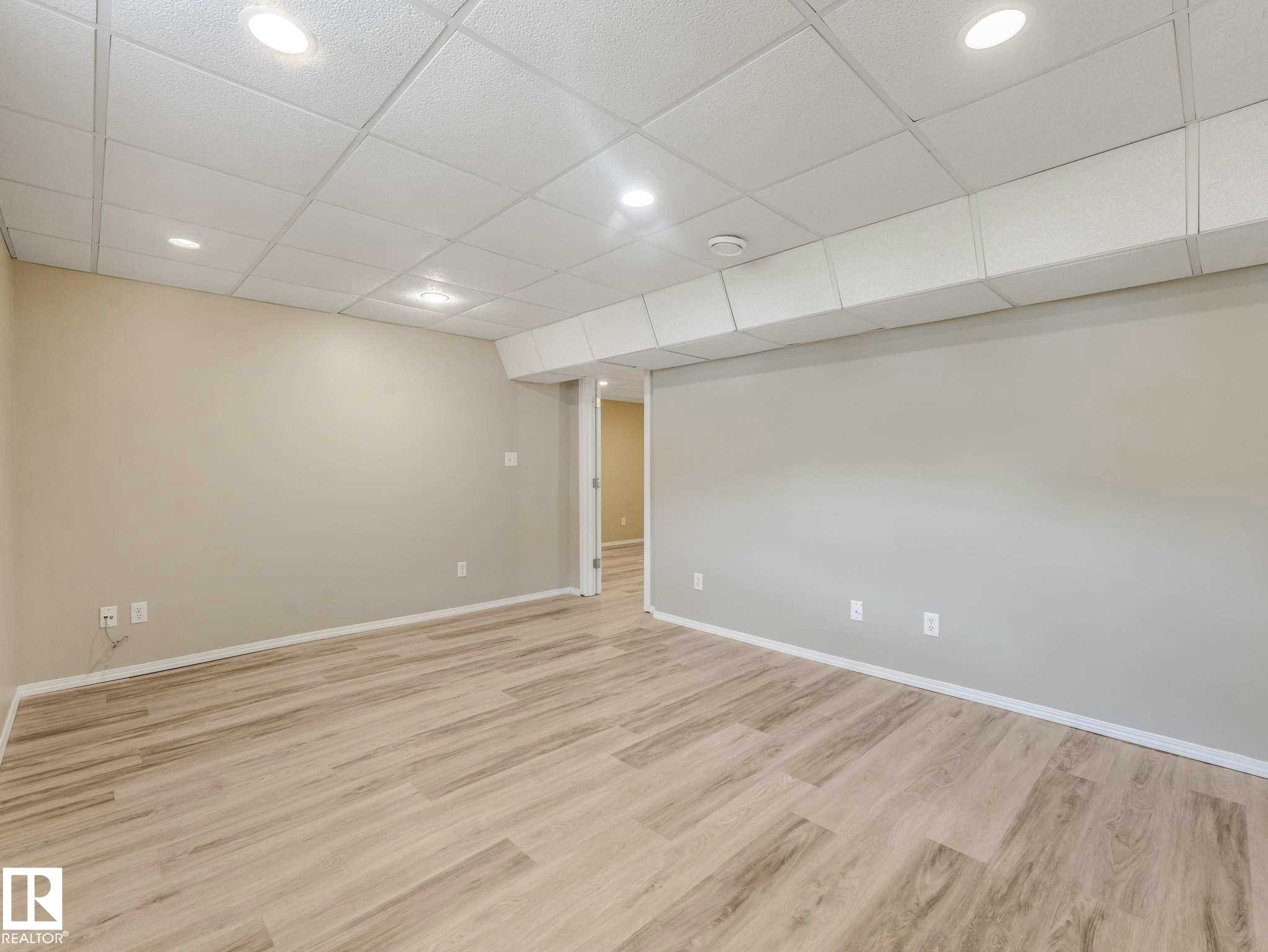 Recessed lighting, drop ceiling, wood-finish flooring, light-toned walls, and neutral trim - 15916 88B Avenue Nw, Edmonton, AB