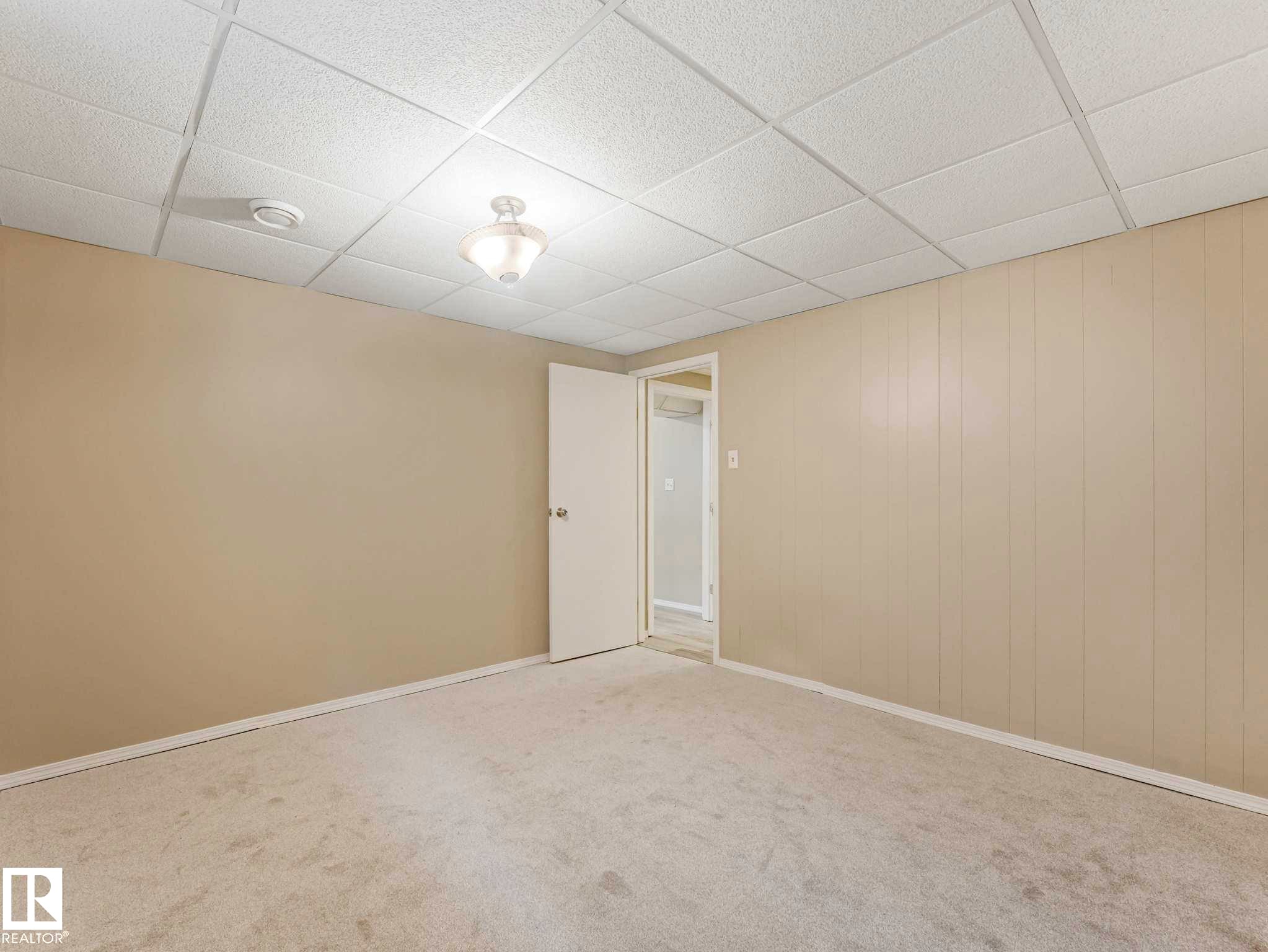 Neutral wall paint, drop ceiling with recessed lighting, and light-toned carpet flooring - 15916 88B Avenue Nw, Edmonton, AB