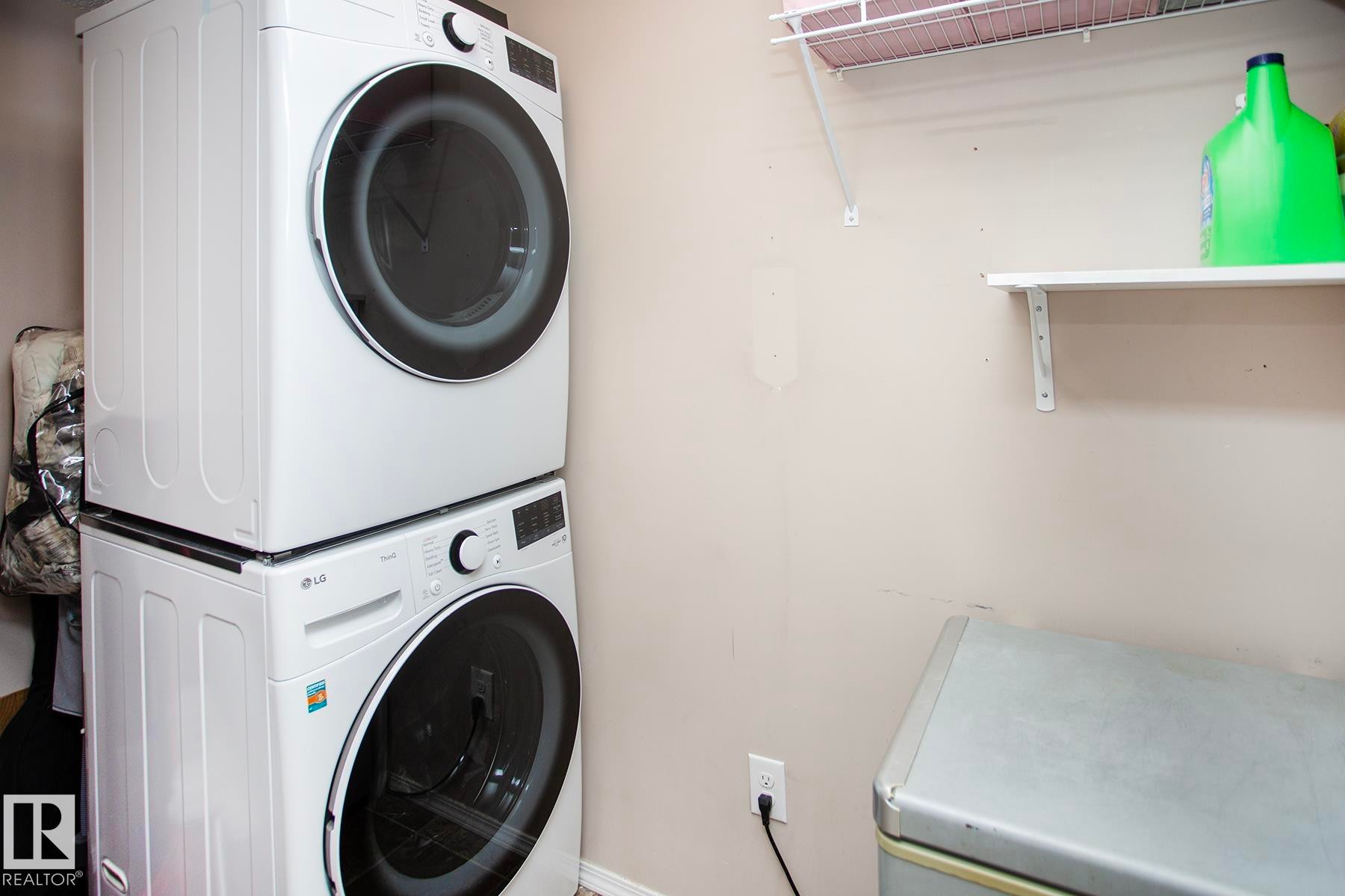 Stackable washer and dryer appliances, wall-mounted shelving - #201 1070 Mcconachie Bv Nw, Edmonton, AB