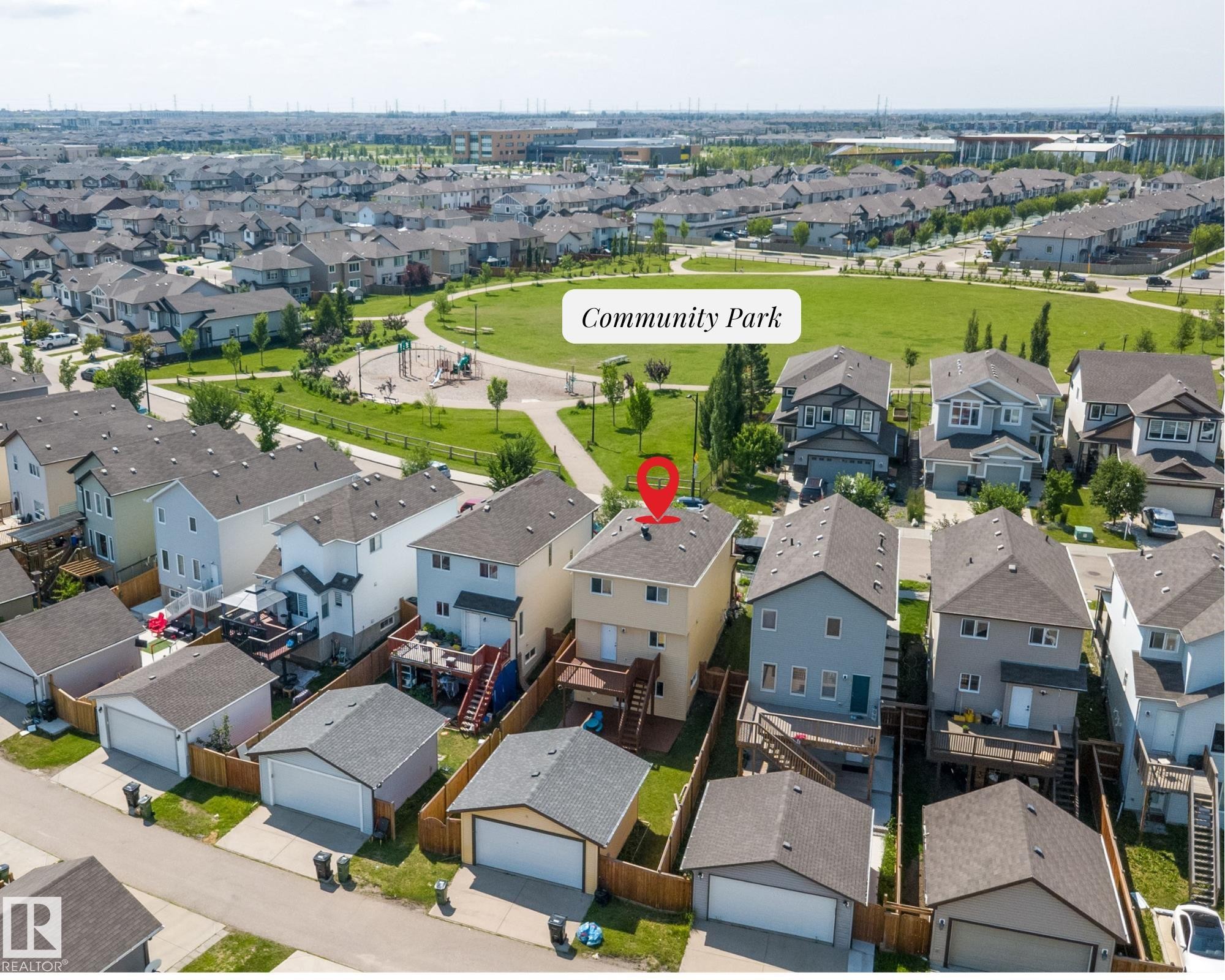 Aerial view of a residential property with a detached garage, featuring a rear deck and a fenced yard - 2803 12 Street Nw, Edmonton, AB