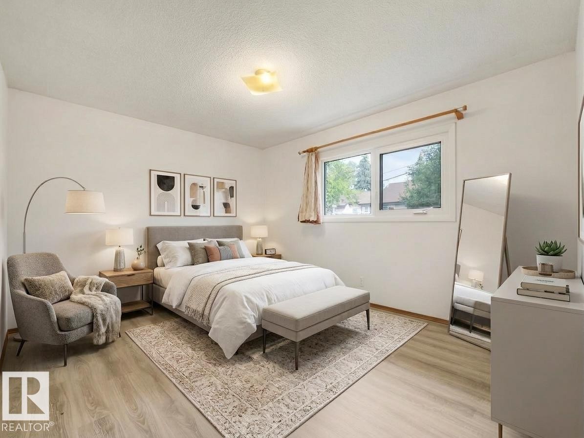 Light wood-finish flooring, white walls, double window, and a flush-mount ceiling light - 16428 88 Avenue Nw, Edmonton, AB