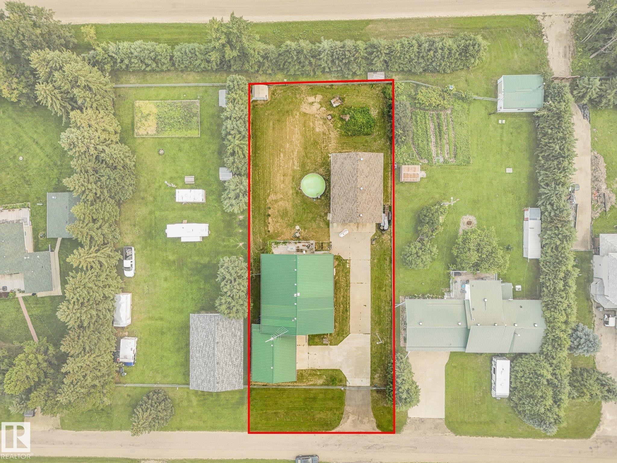 Aerial perspective showcasing a property with a main residence and a detached garage - 54 Buskmose Dr, Rural Wetaskiwin County, AB - Other