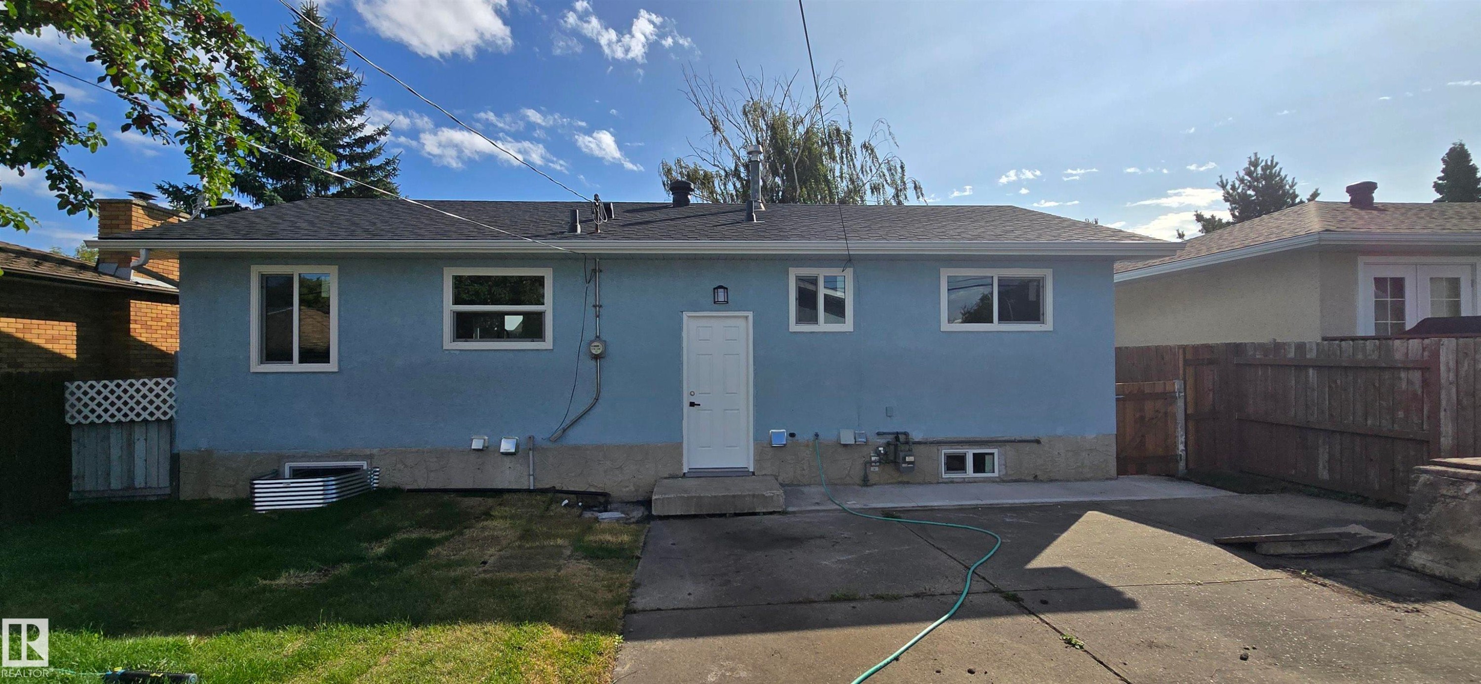 Light blue exterior with white trim windows and door - 13812 63 Street Nw, Edmonton, AB