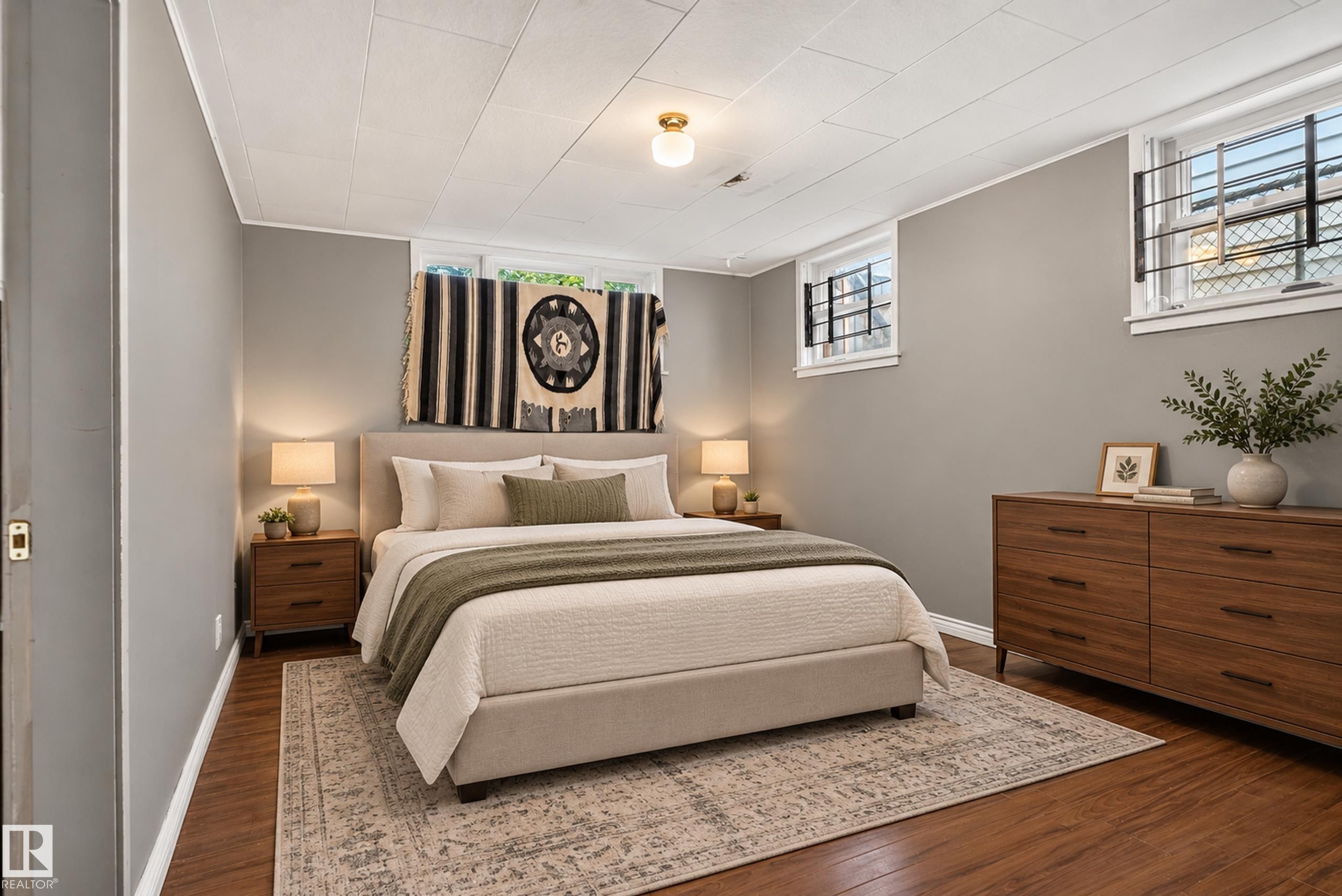 Wood-finish flooring, light gray walls, white ceiling panels, and recessed lighting - 11406 83 Street Nw, Edmonton, AB