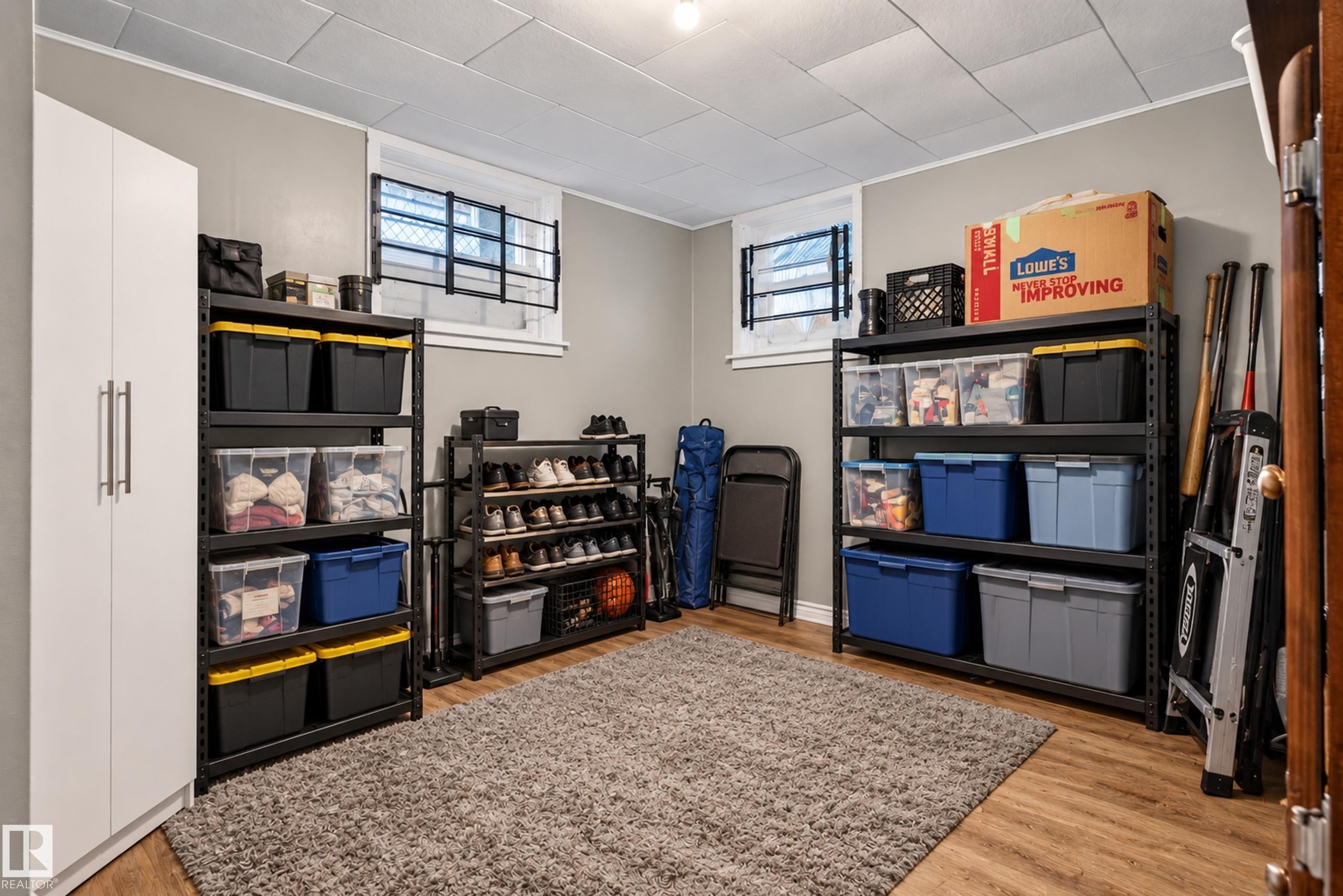 Wood-finish flooring, drop ceiling, and light gray wall paint - 11406 83 Street Nw, Edmonton, AB