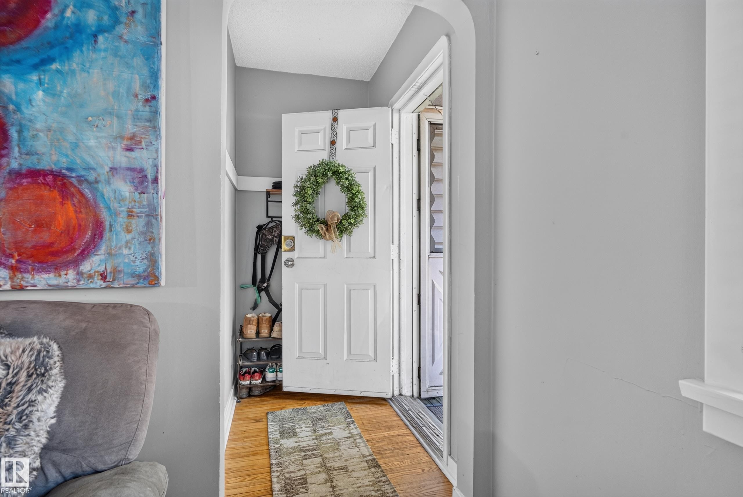 Hardwood flooring, painted interior walls, and a white paneled door - 11406 83 Street Nw, Edmonton, AB