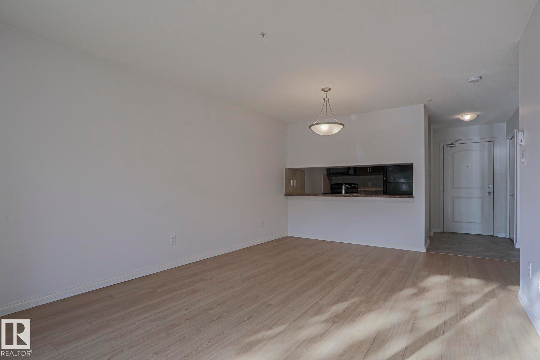 Open concept living space featuring wood-finish flooring - #108 1204 156 St Nw, Edmonton, AB