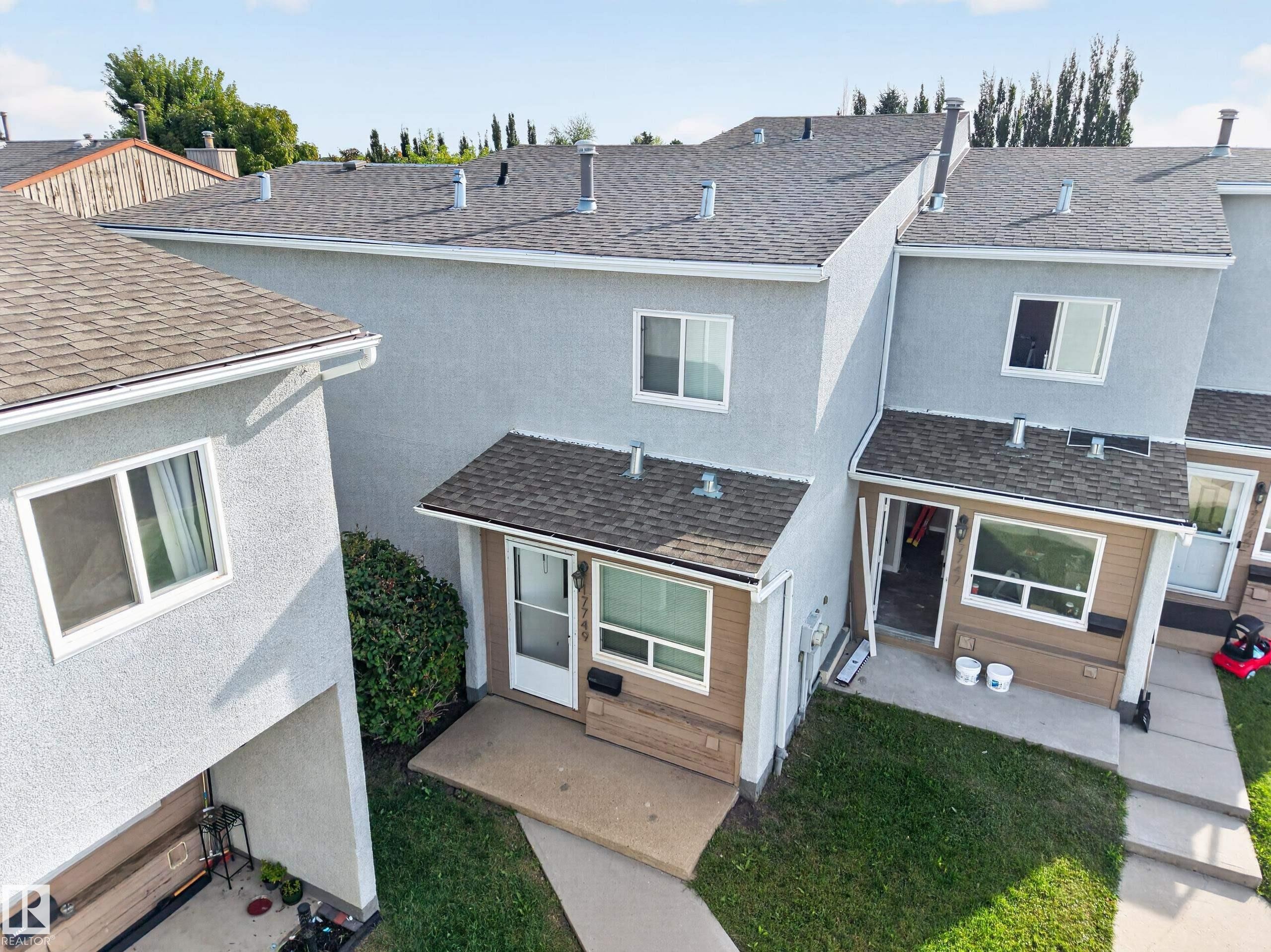 Multi-level exterior with stucco finish and asphalt shingle roof - 17749 95 Street Nw, Edmonton, AB