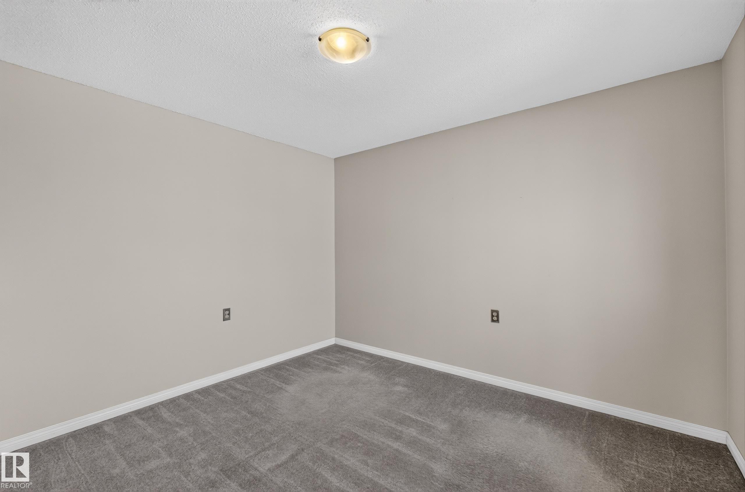 Recessed ceiling light fixture, neutral wall paint, white trim, and gray carpeting - 17749 95 Street Nw, Edmonton, AB