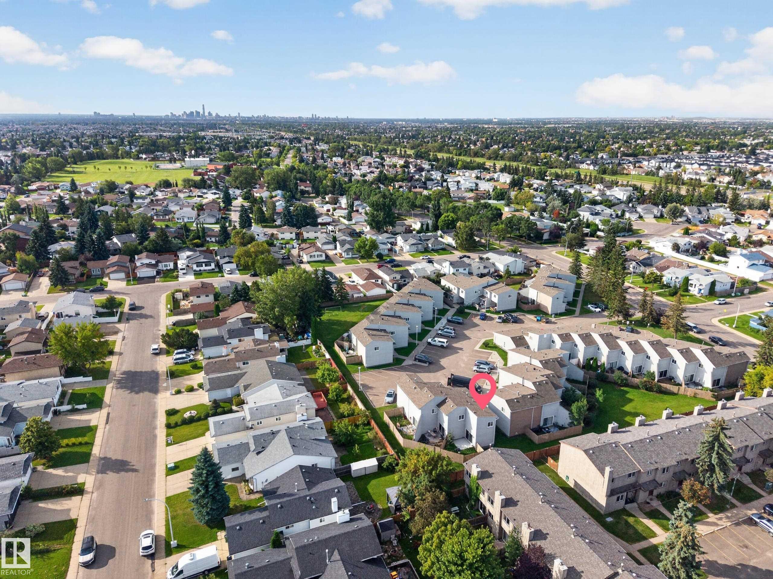 Residential neighborhood with varied housing styles, mature trees, and visible green spaces - 17749 95 Street Nw, Edmonton, AB
