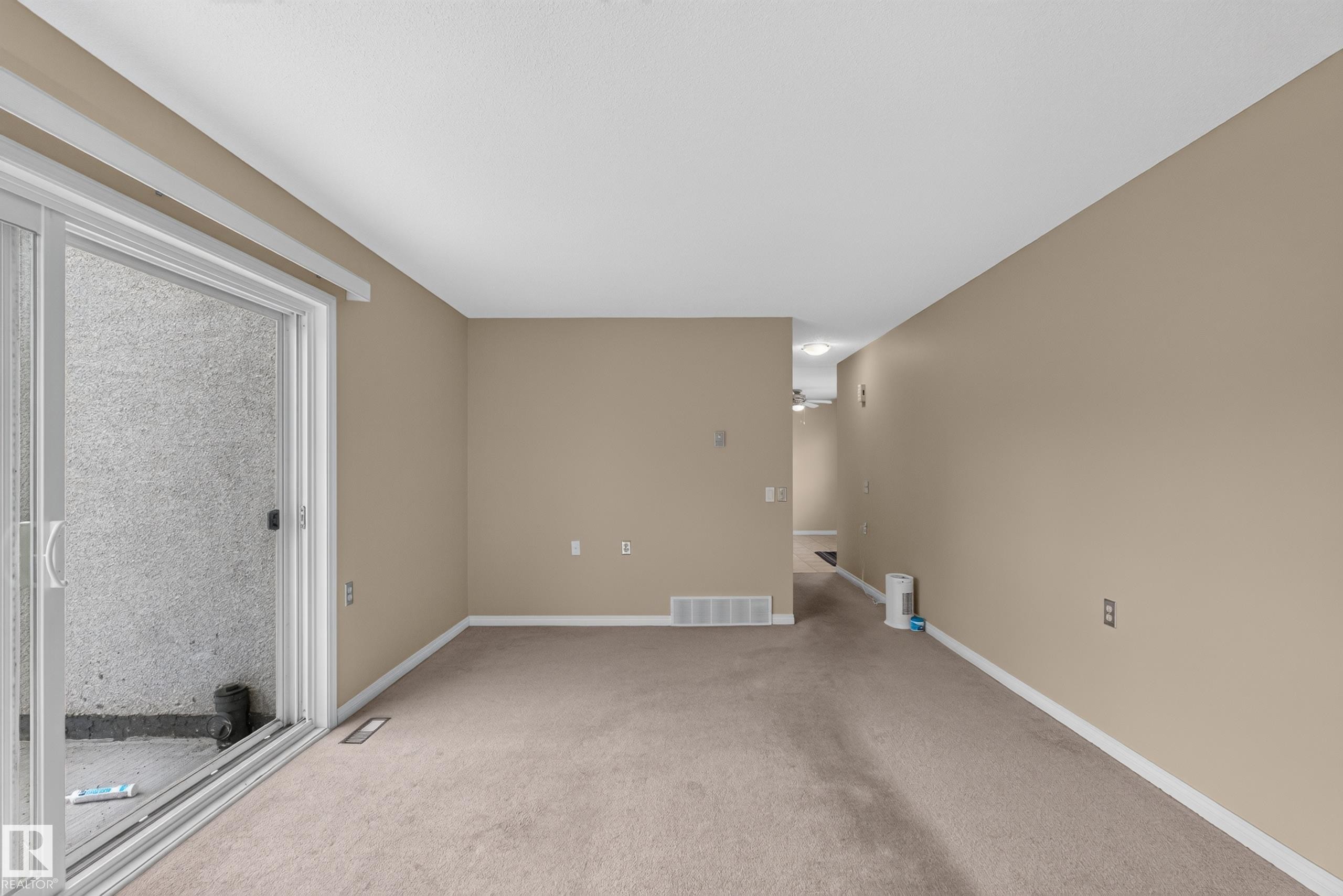Neutral wall color, carpet flooring, sliding glass door, white trim, recessed lighting - 17749 95 Street Nw, Edmonton, AB