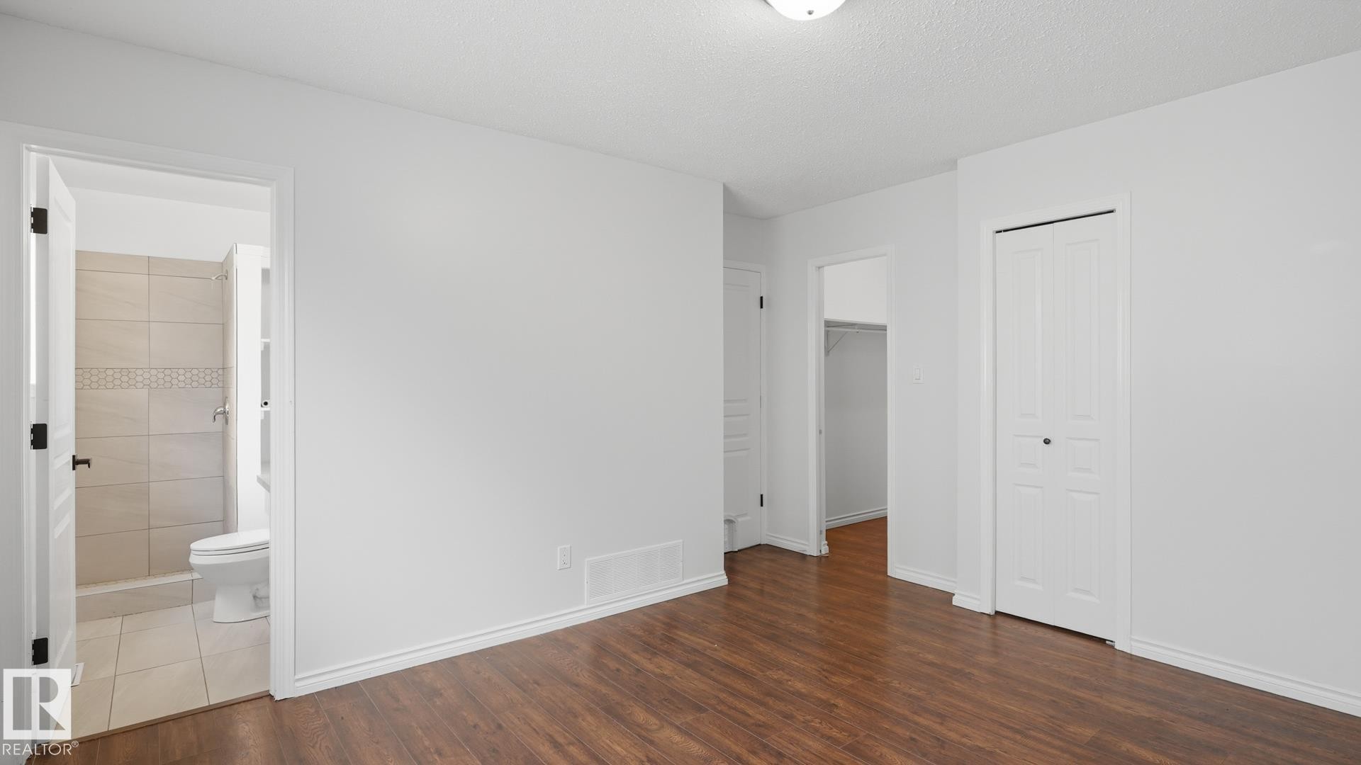 Wood-finish flooring, white walls, and white trim - 12208 146 Avenue Nw, Edmonton, AB