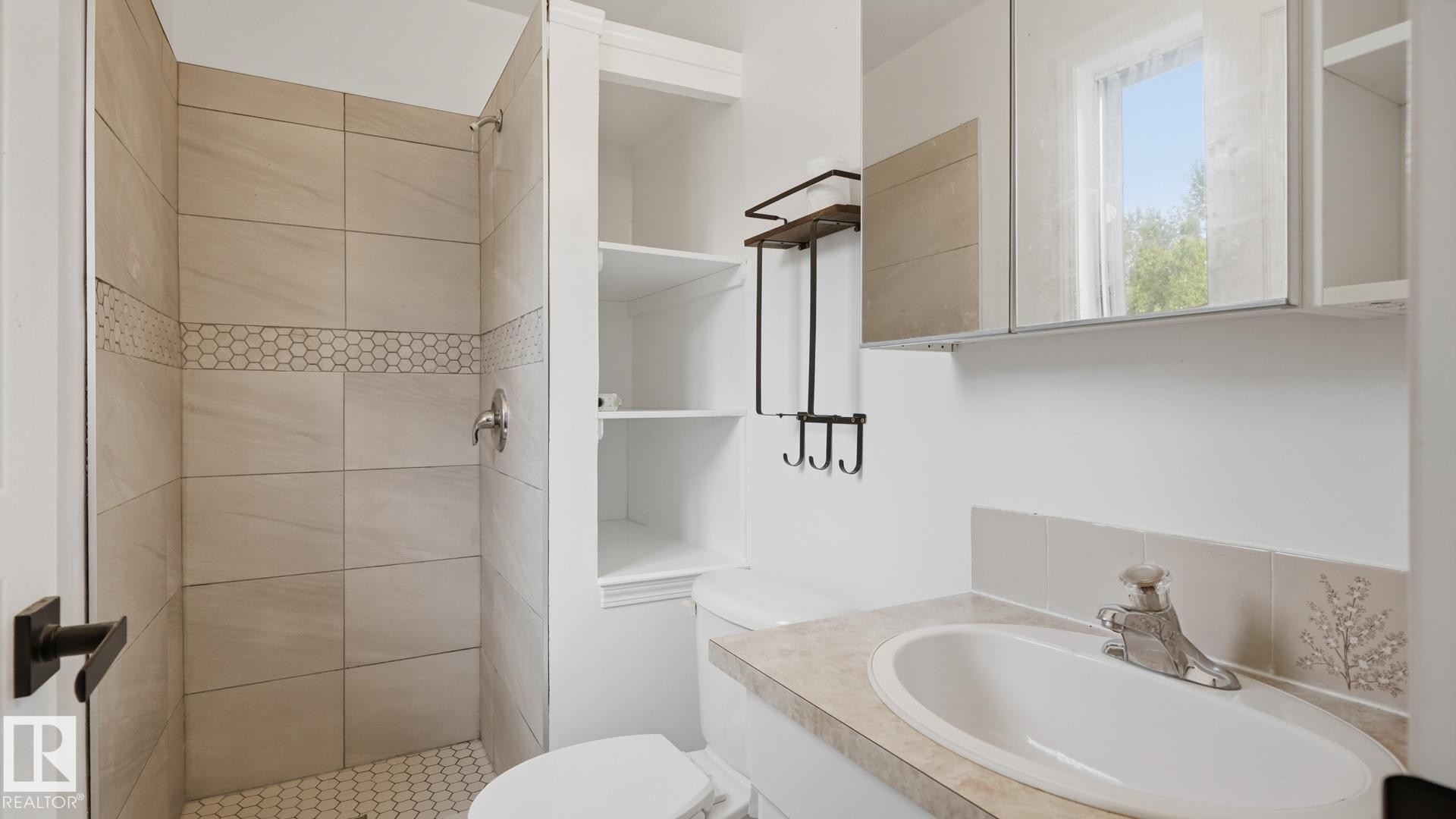 Walk-in shower with tiled surround and hex tile floor - 12208 146 Avenue Nw, Edmonton, AB