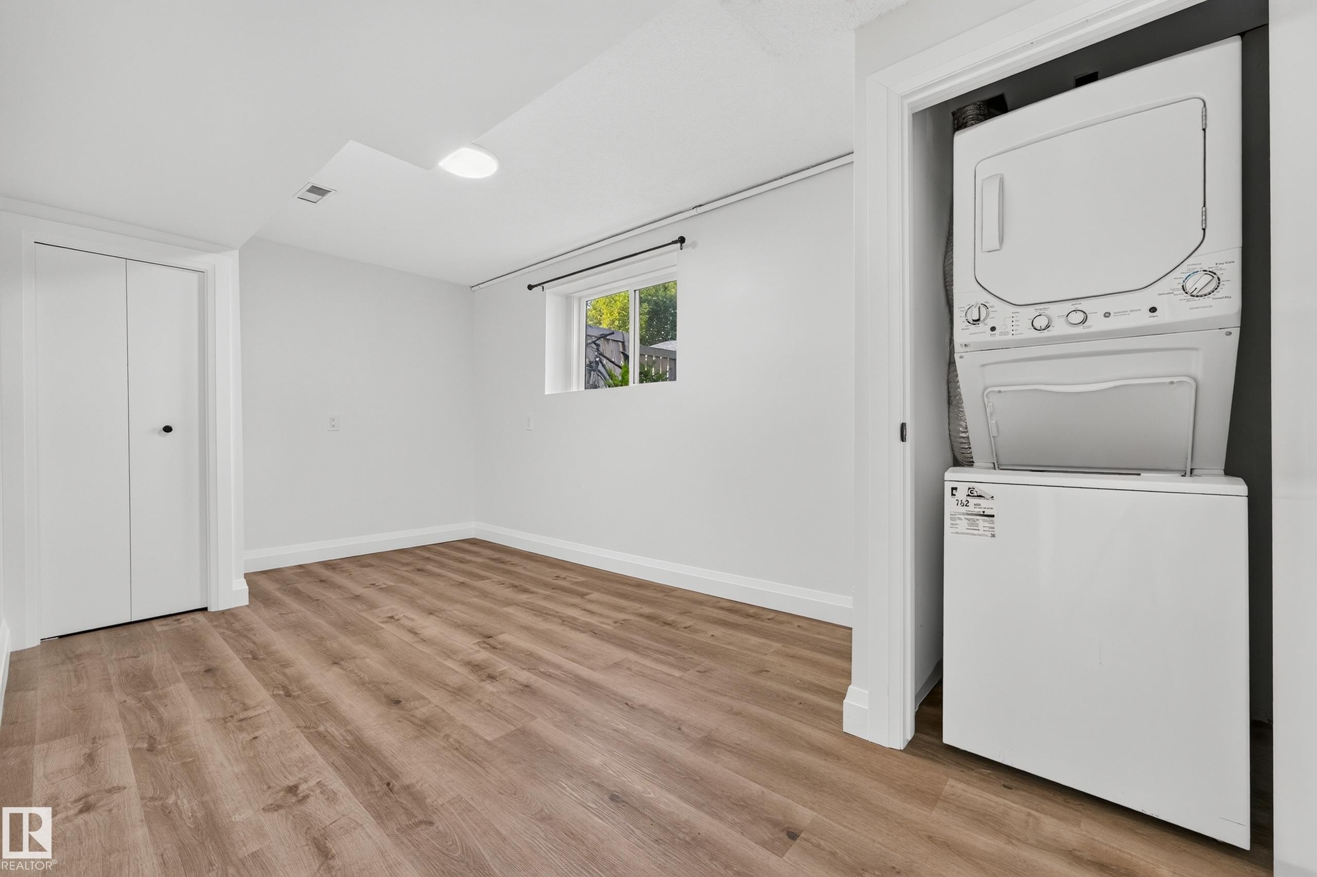 Wood-finish flooring, white walls, and a recessed window - 2412 80 Street Nw, Edmonton, AB