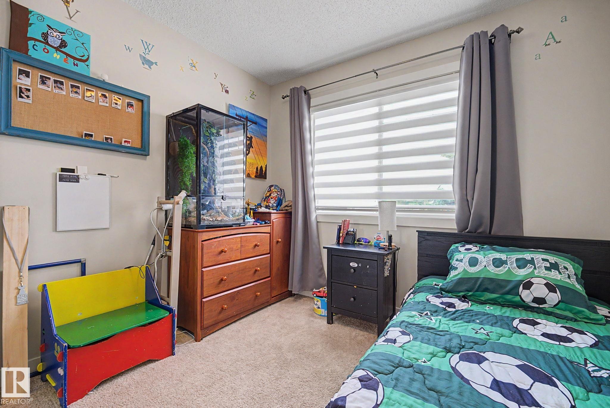 Window with horizontal blinds and full-length drapery panels - 3343 Weidle Way Sw, Edmonton, AB