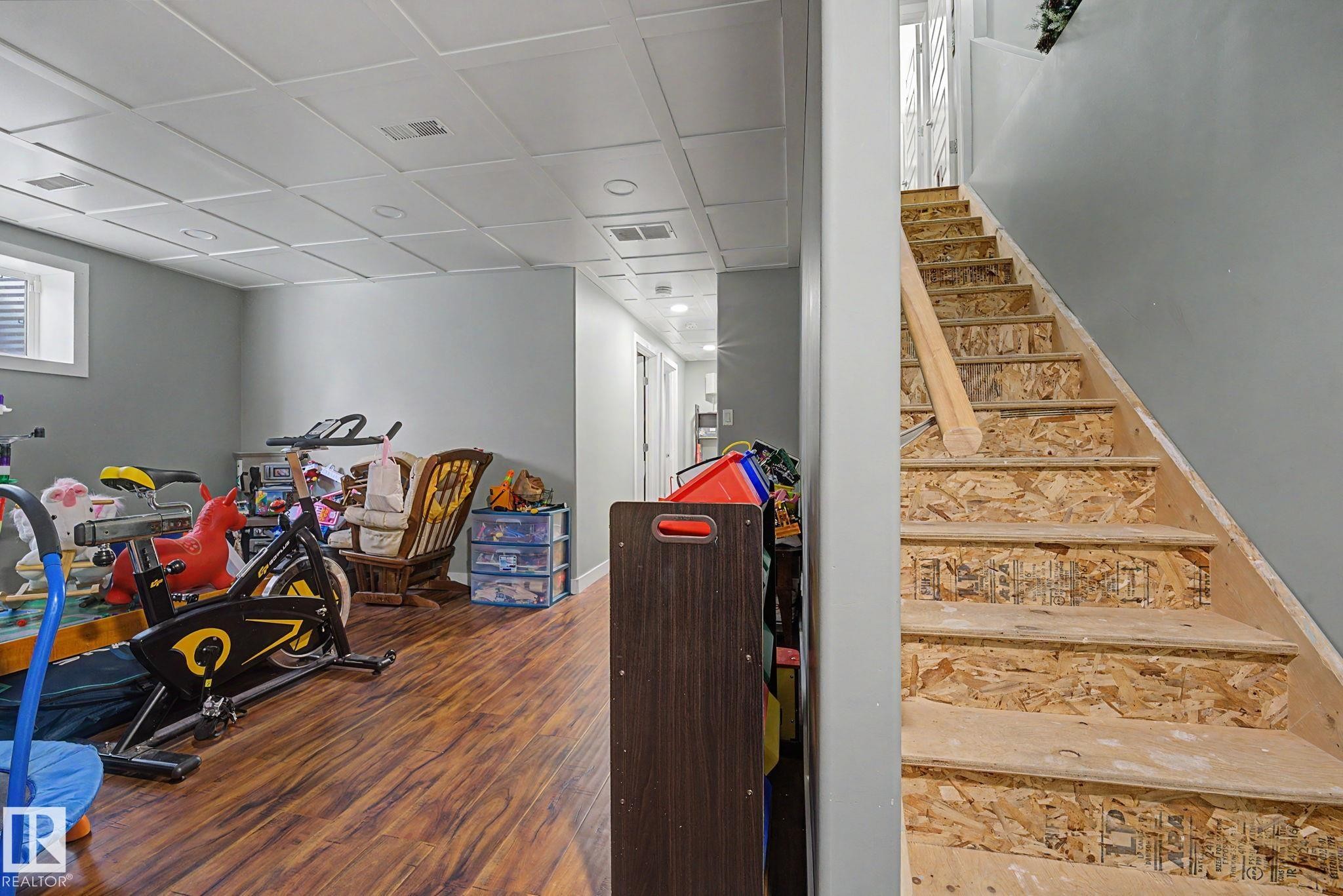 Finished lower level featuring recessed lighting and wood-finish flooring - 3343 Weidle Way Sw, Edmonton, AB