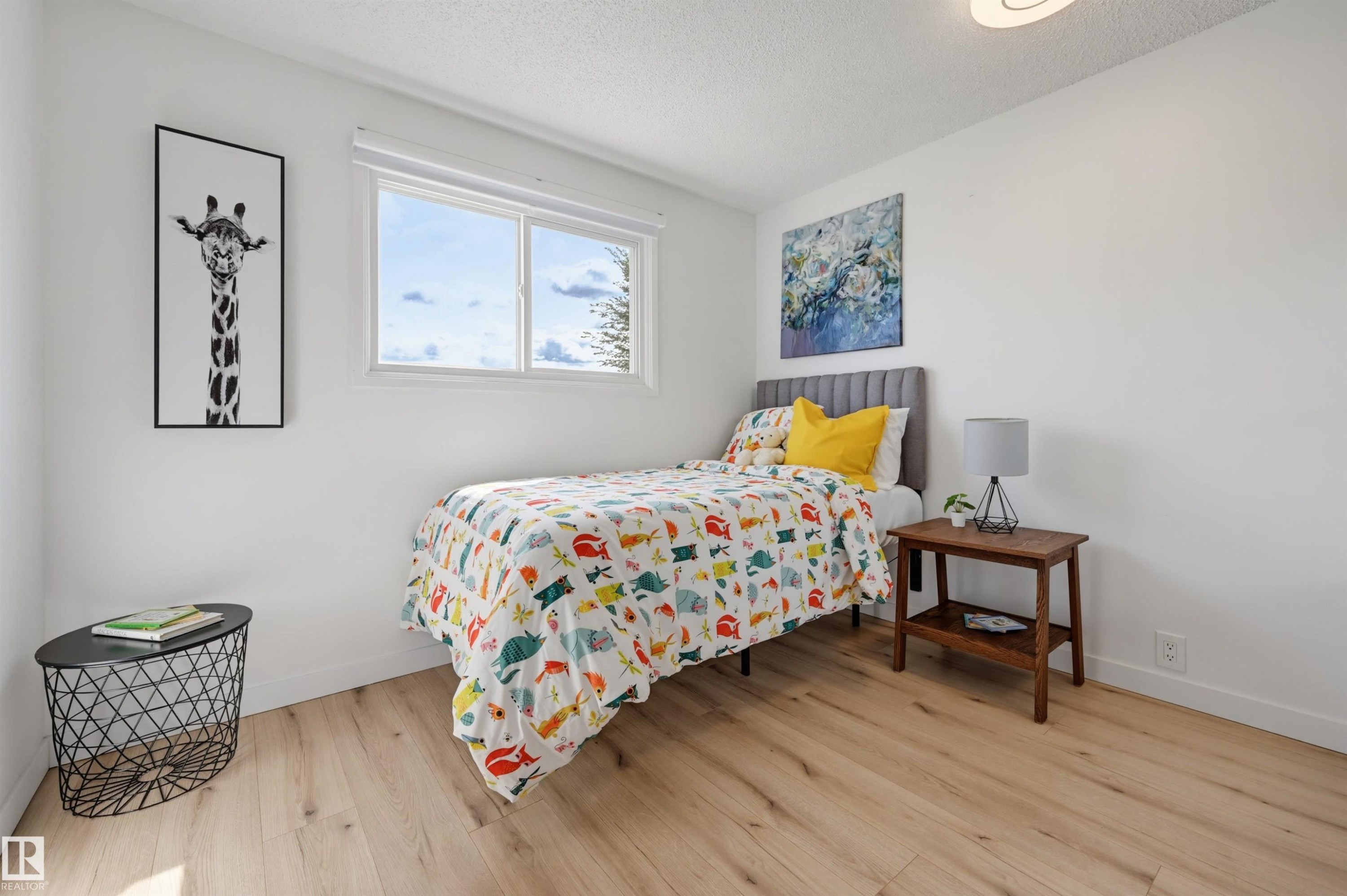 Light wood-finish flooring, white walls, and a white framed window - 4125 38 Street Nw, Edmonton, AB