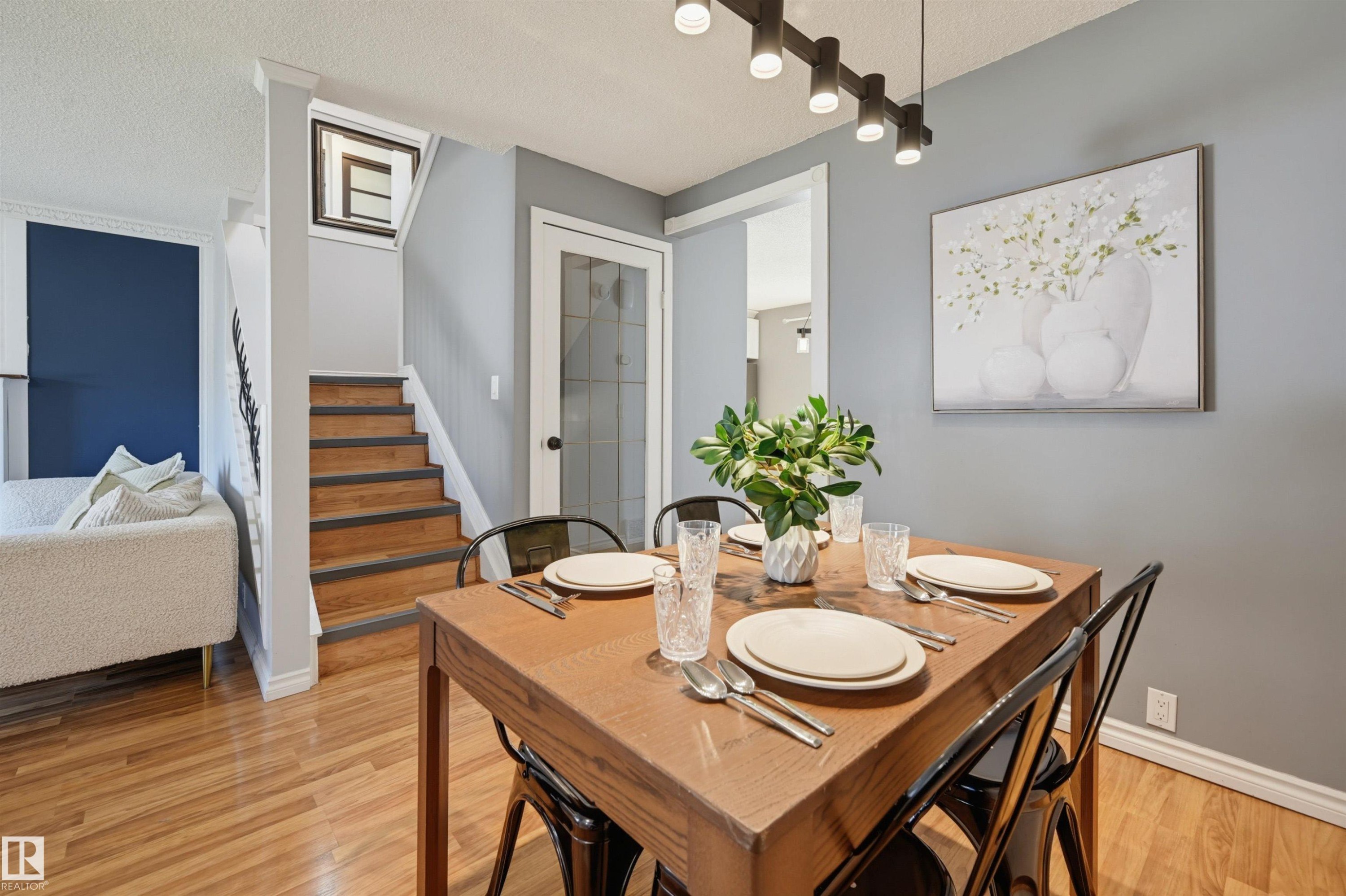 Wood-finish flooring throughout, complemented by a light gray wall color - 4125 38 Street Nw, Edmonton, AB