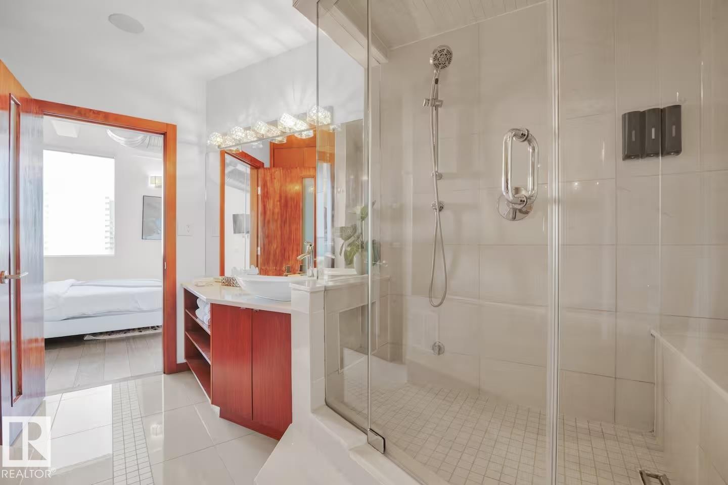 Glass-enclosed shower with a handheld showerhead and built-in bench - #701 10105 109 St Nw, Edmonton, AB