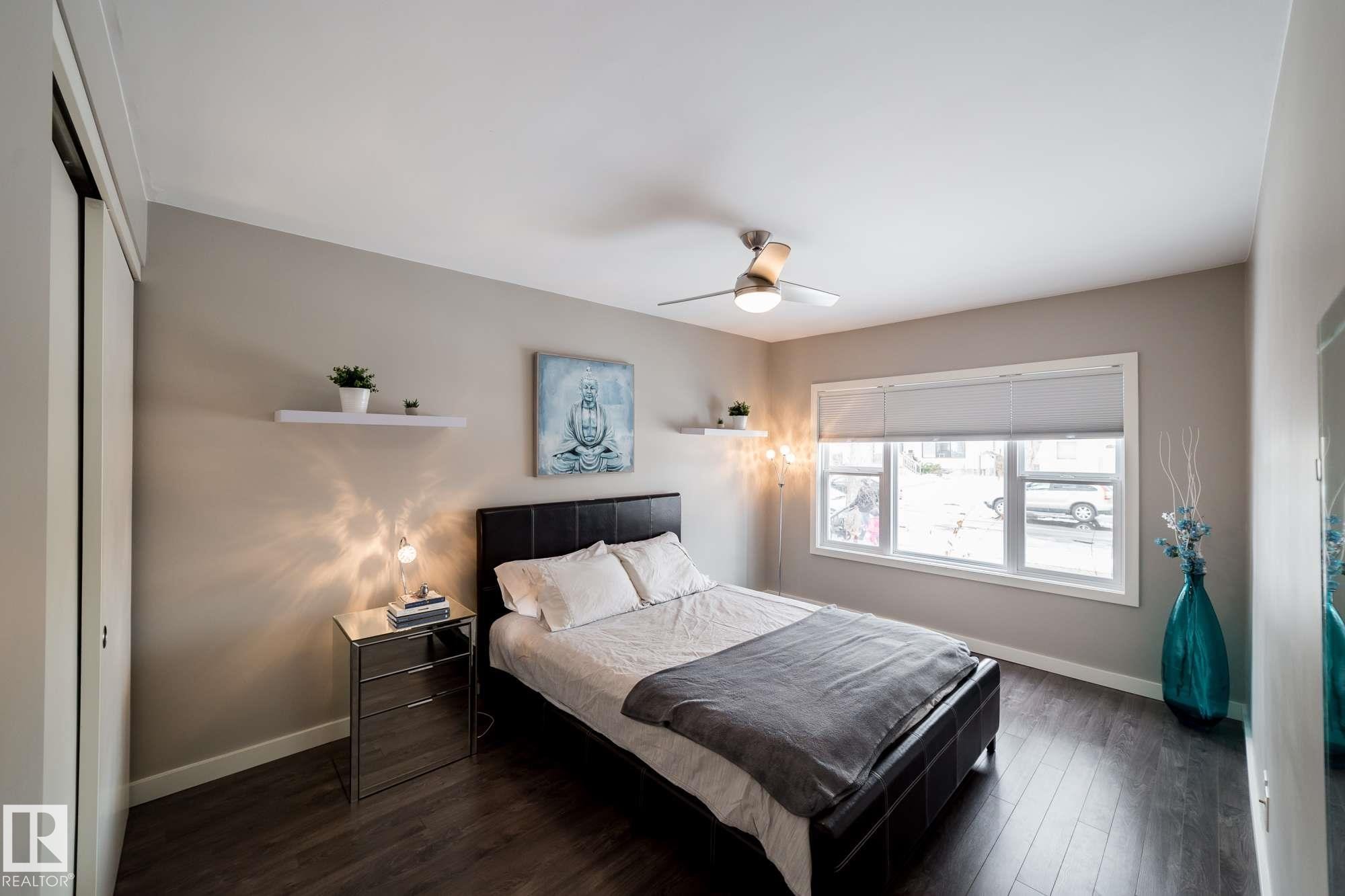 Wood-finish flooring, full-light window, and overhead ceiling fan - 12228 134 Street Nw, Edmonton, AB
