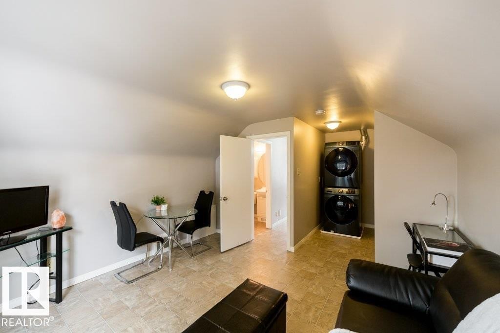 Sloped ceilings, neutral wall tones, and square tile flooring - 12228 134 Street Nw, Edmonton, AB