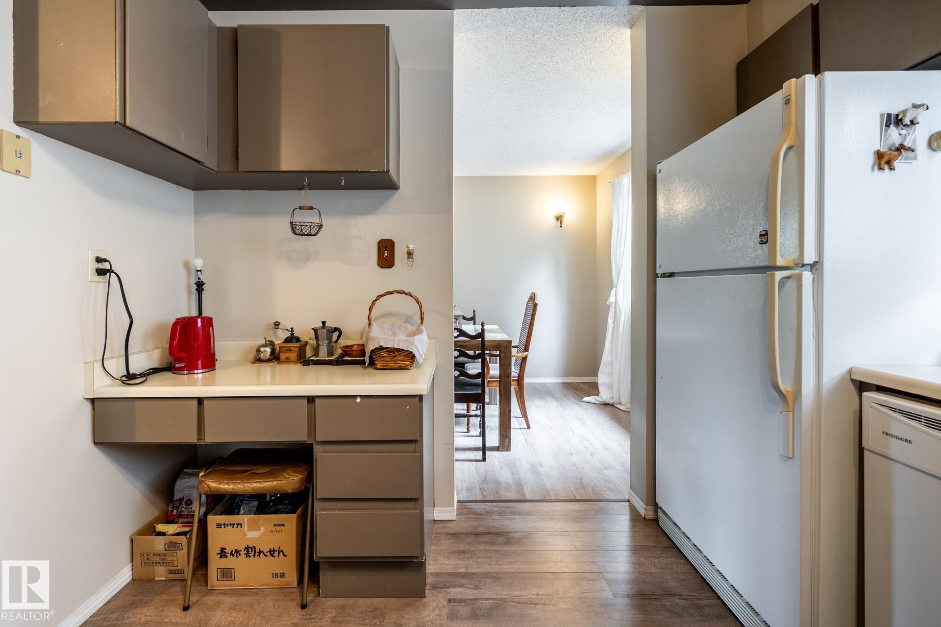 Kitchen area featuring neutral-toned cabinetry and a white countertop - #20 3812 20 Av Nw, Edmonton, AB