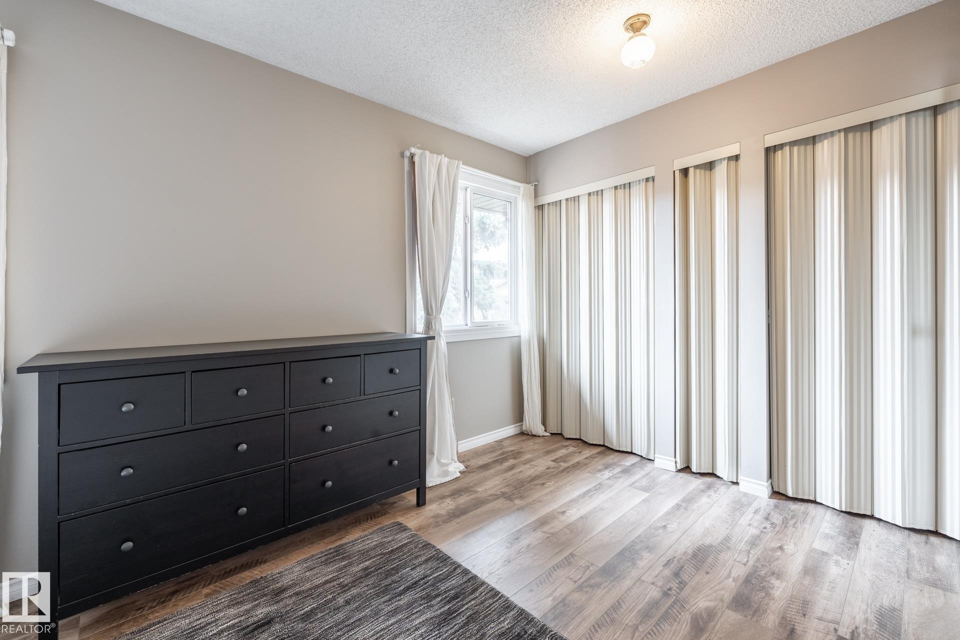 Room featuring light wood-finish flooring and neutral wall paint - #20 3812 20 Av Nw, Edmonton, AB