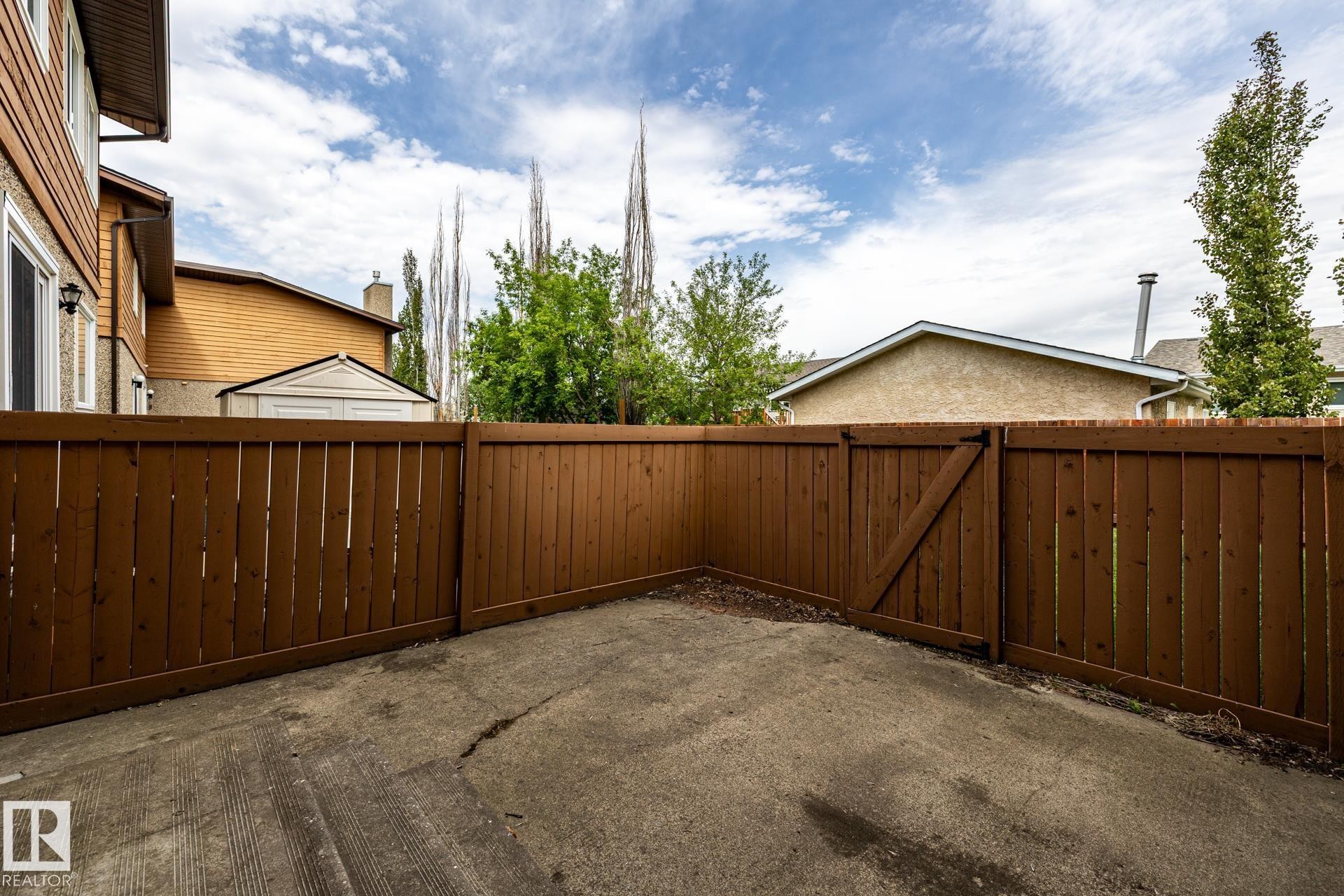 Private outdoor area with a wood fence and concrete pad - #20 3812 20 Av Nw, Edmonton, AB