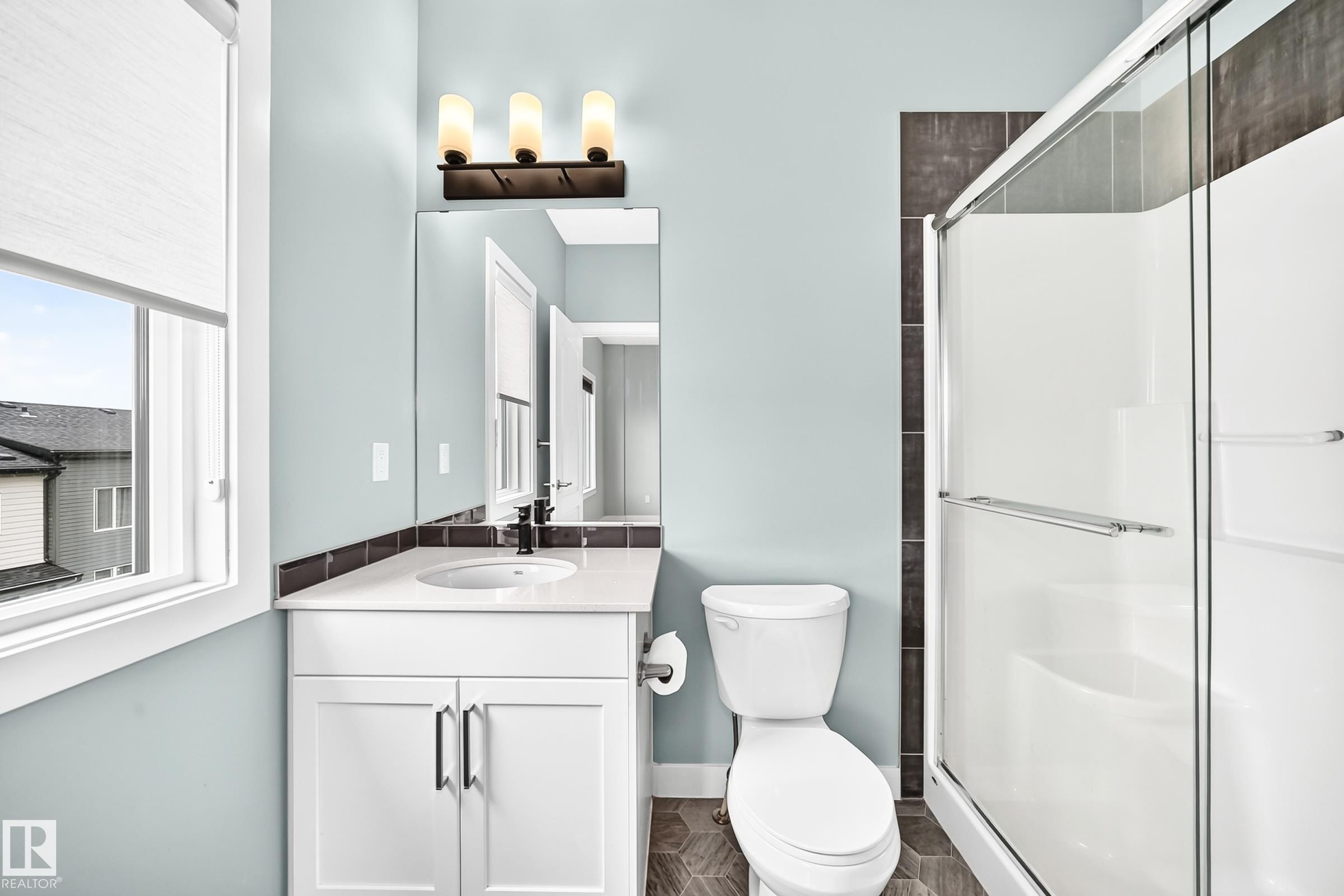 Single vanity with white cabinetry, quartz countertop, and undermount sink - #56 804 Welsh Dr Sw, Edmonton, AB