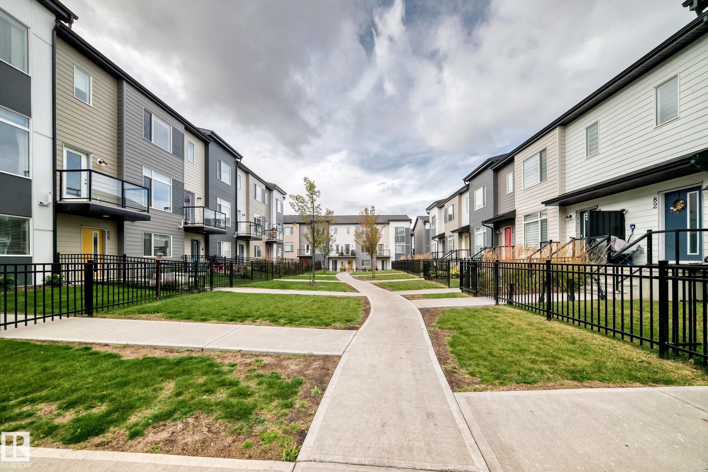 Modern townhome development featuring multiple units with individual balconies and dedicated entryways - #56 804 Welsh Dr Sw, Edmonton, AB