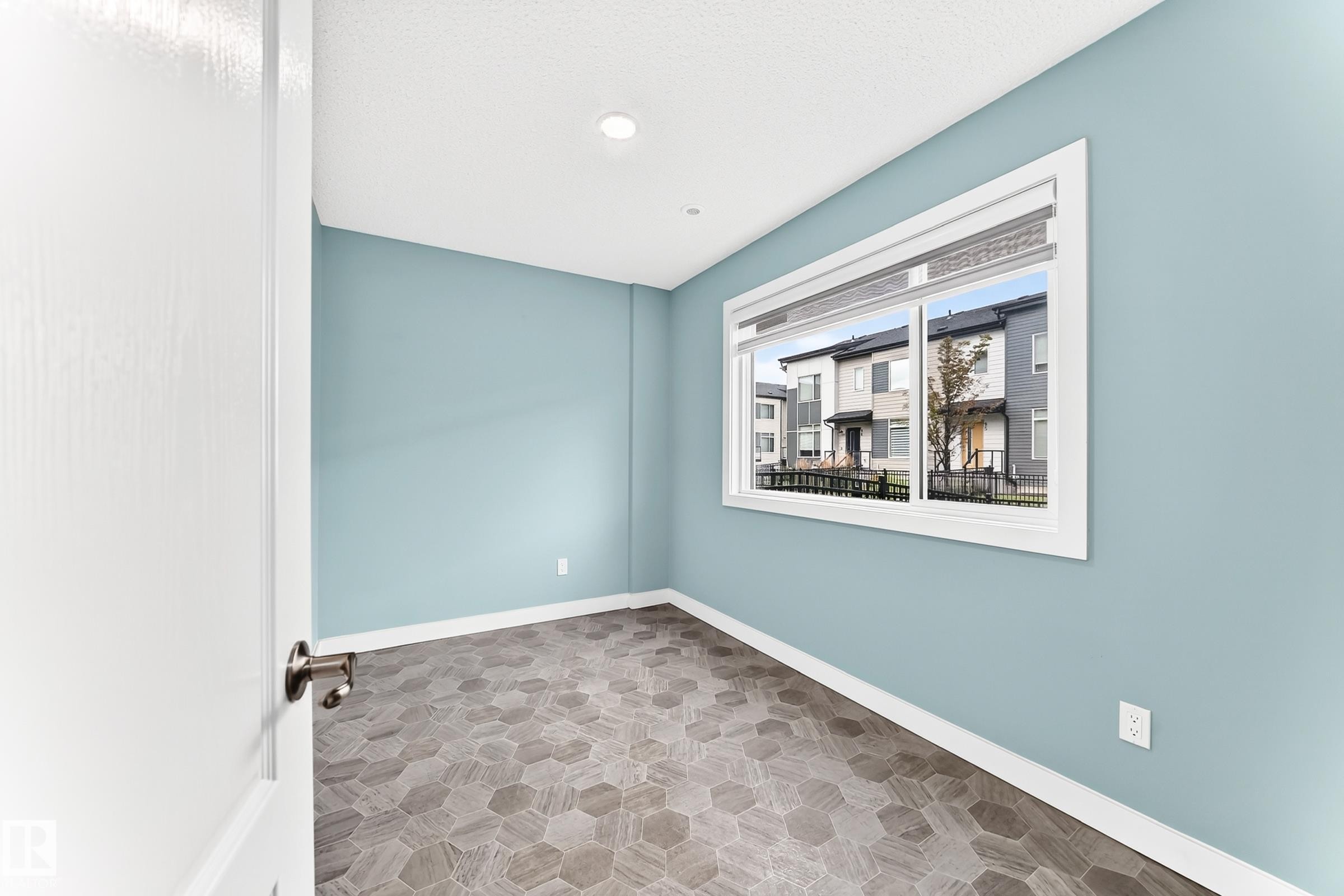 Hexagonal tile flooring, light blue wall paint, white trim, recessed ceiling lighting, and a white-framed window - #56 804 Welsh Dr Sw, Edmonton, AB