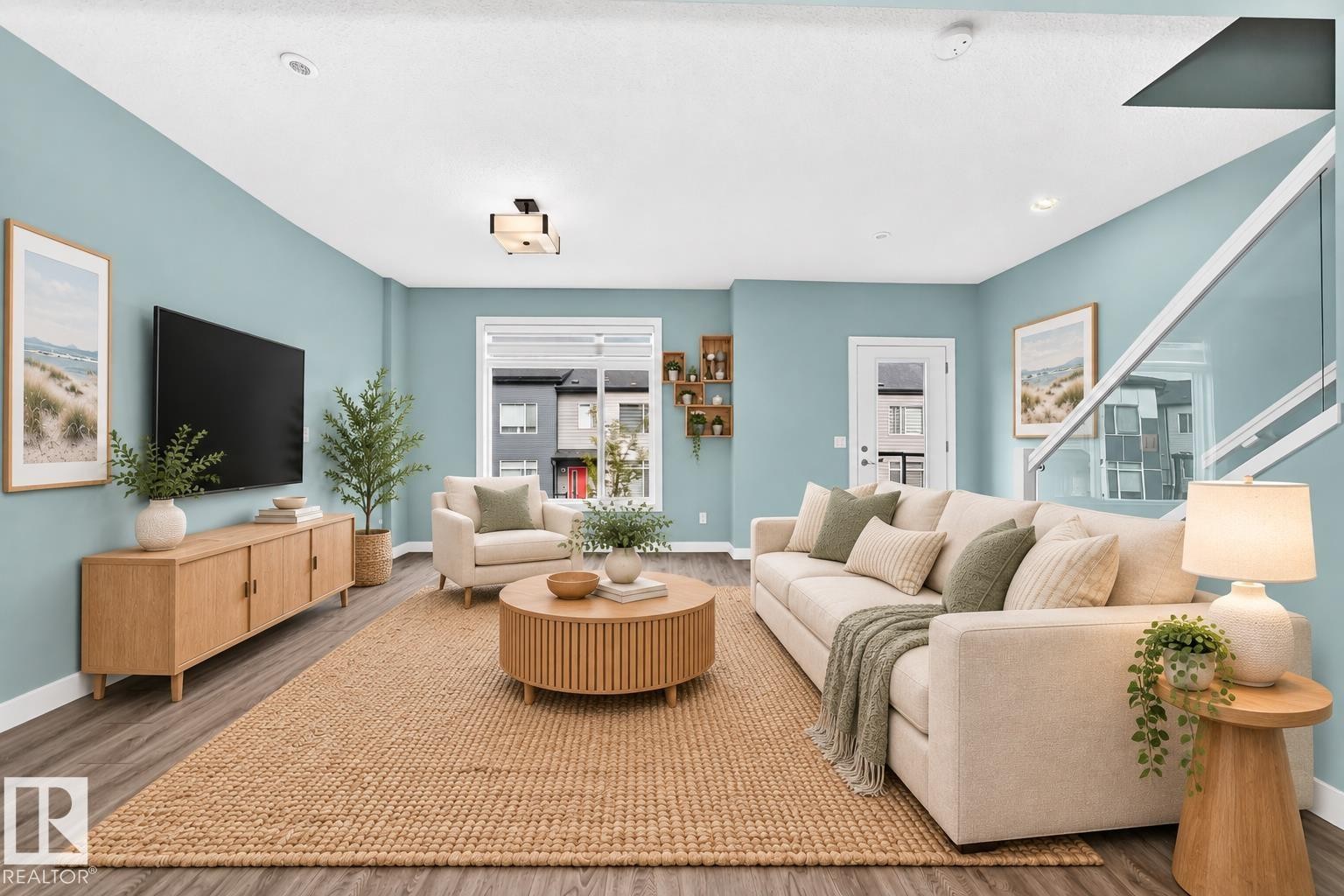 Recessed ceiling lighting, wood-finish flooring, large window with ample natural light, modern ceiling light fixture, and glass panel stair railing - #56 804 Welsh Dr Sw, Edmonton, AB