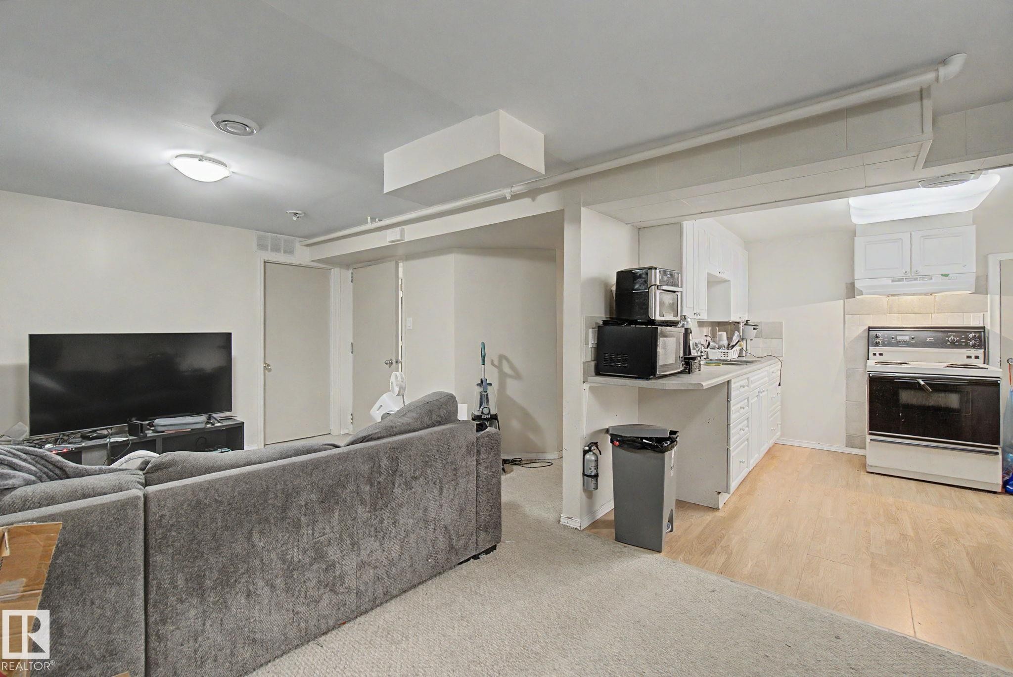 Open concept area featuring a kitchen and living space - 8710 83 Avenue Nw, Edmonton, AB - Indoor