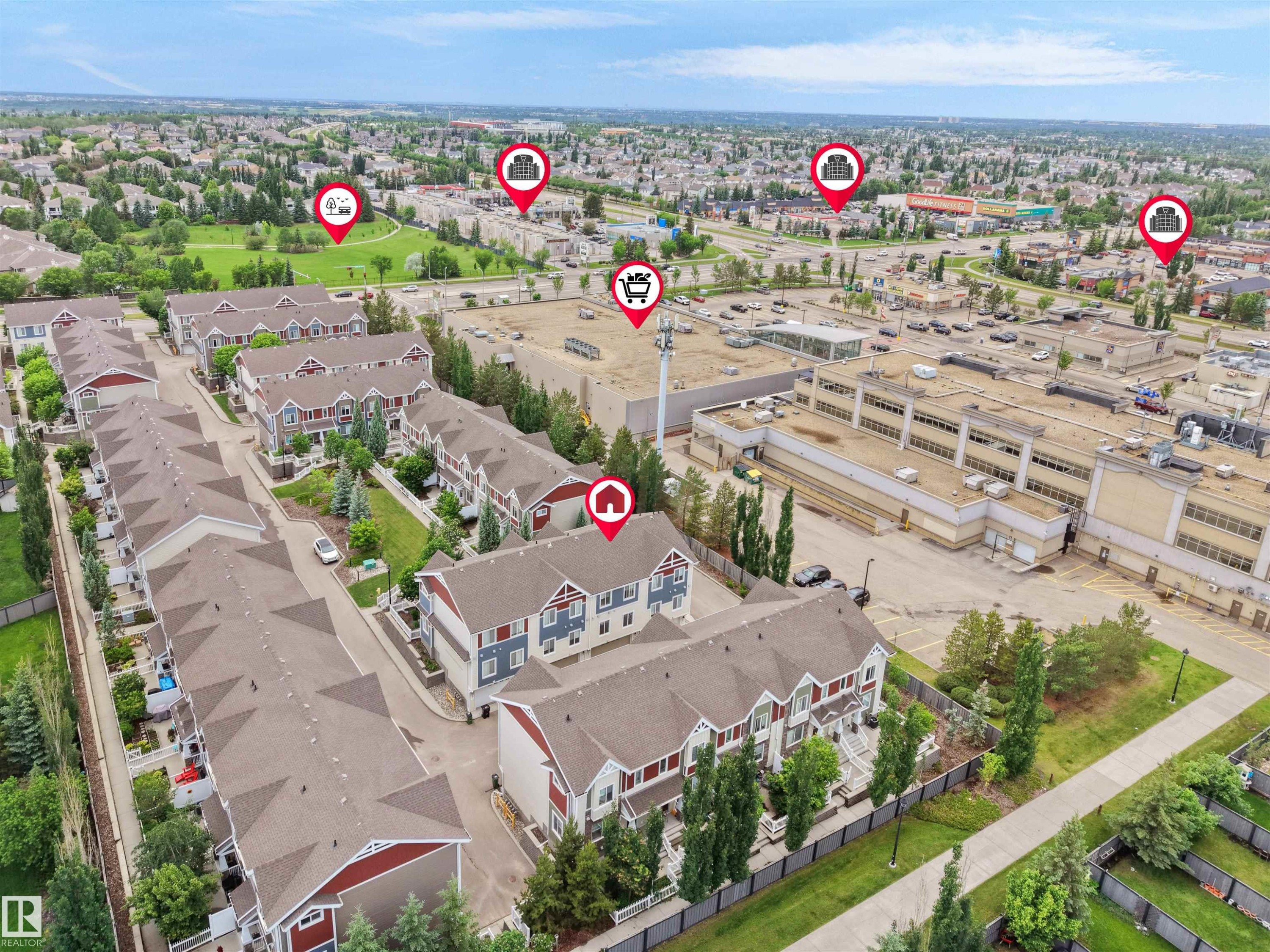 Townhome community with varied exterior finishes, abundant green spaces, and paved pathways - #40 2003 Rabbit Hill Rd Nw, Edmonton, AB