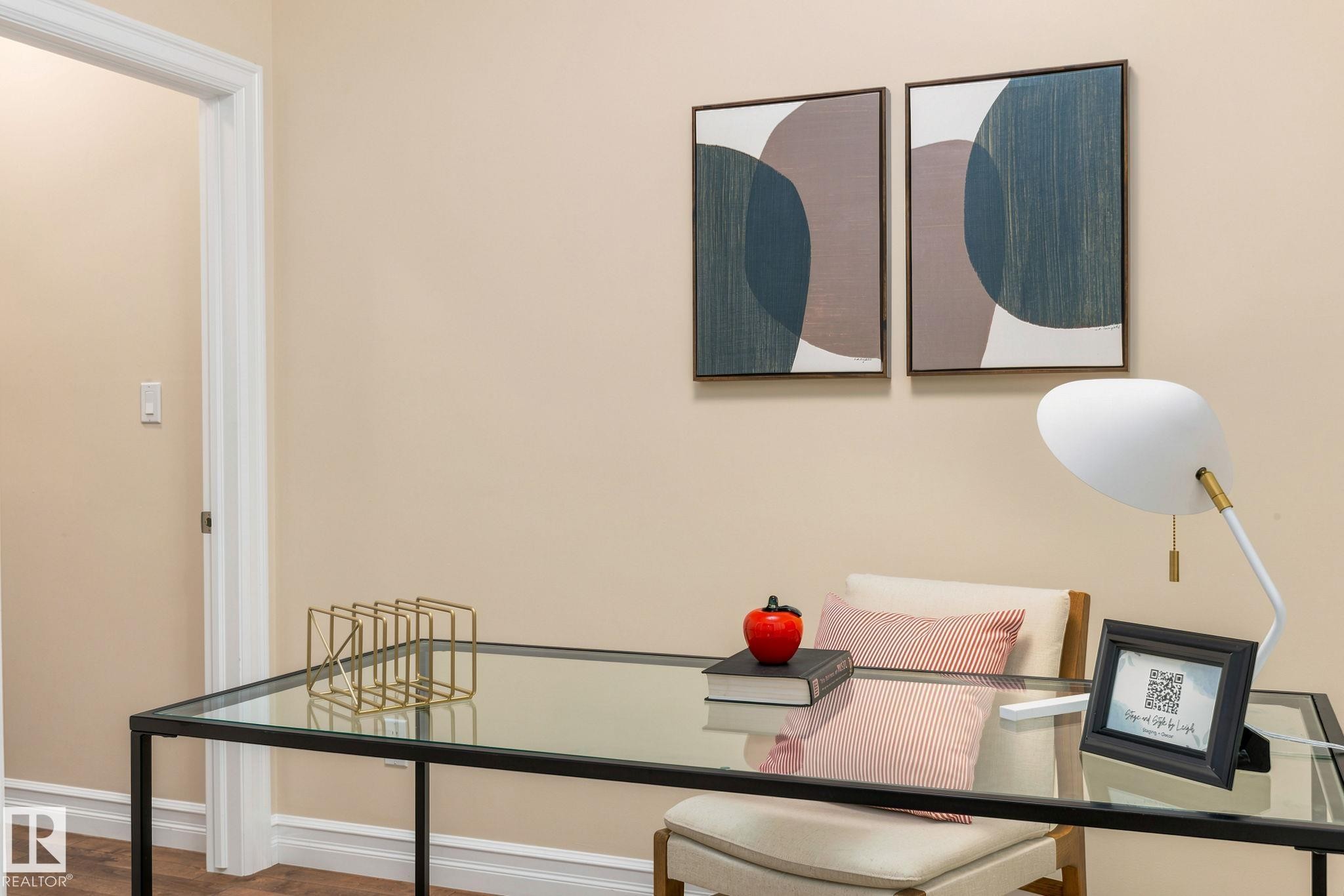 Glass-top desk with a metal frame, wood-finish flooring, and light-toned wall paint - 10143 123 Street Nw, Edmonton, AB