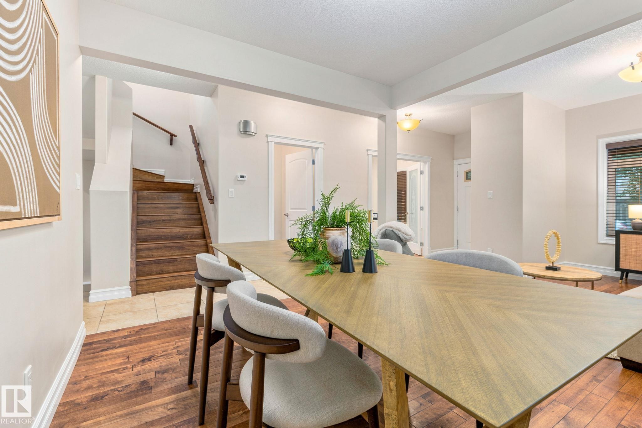 Wood-finish flooring throughout, featuring a natural wood staircase with a matching handrail - 10143 123 Street Nw, Edmonton, AB