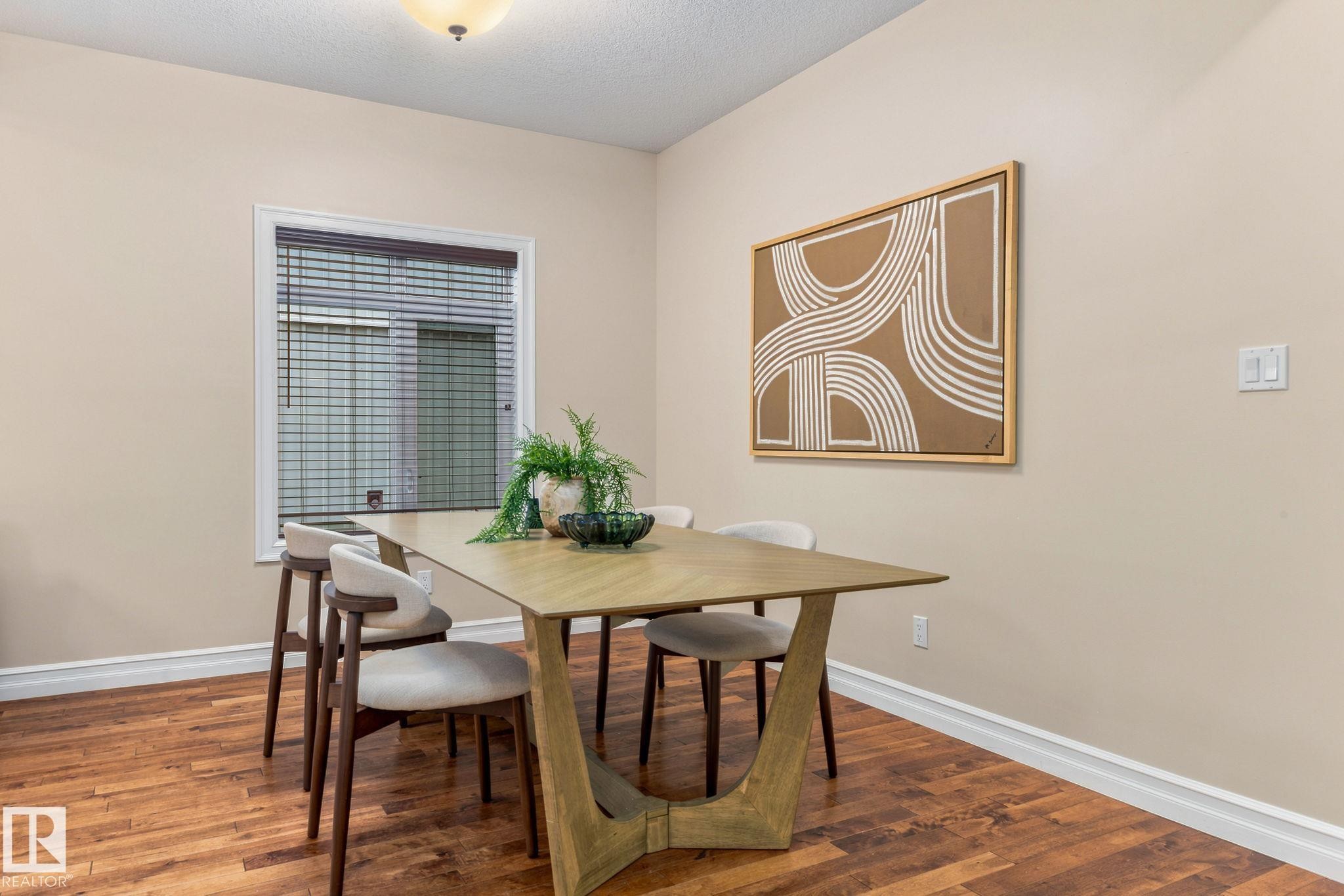 Wood-finish flooring, neutral wall color, white trim, and a window with blinds - 10143 123 Street Nw, Edmonton, AB