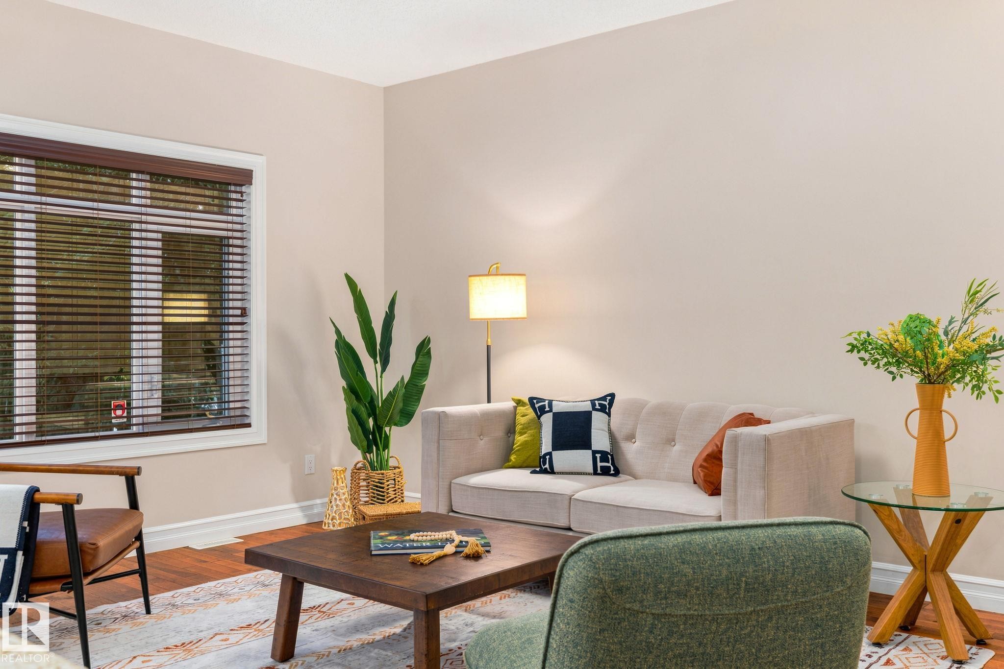 Hardwood-finish flooring, white window trim with blinds, and neutral wall tones - 10143 123 Street Nw, Edmonton, AB