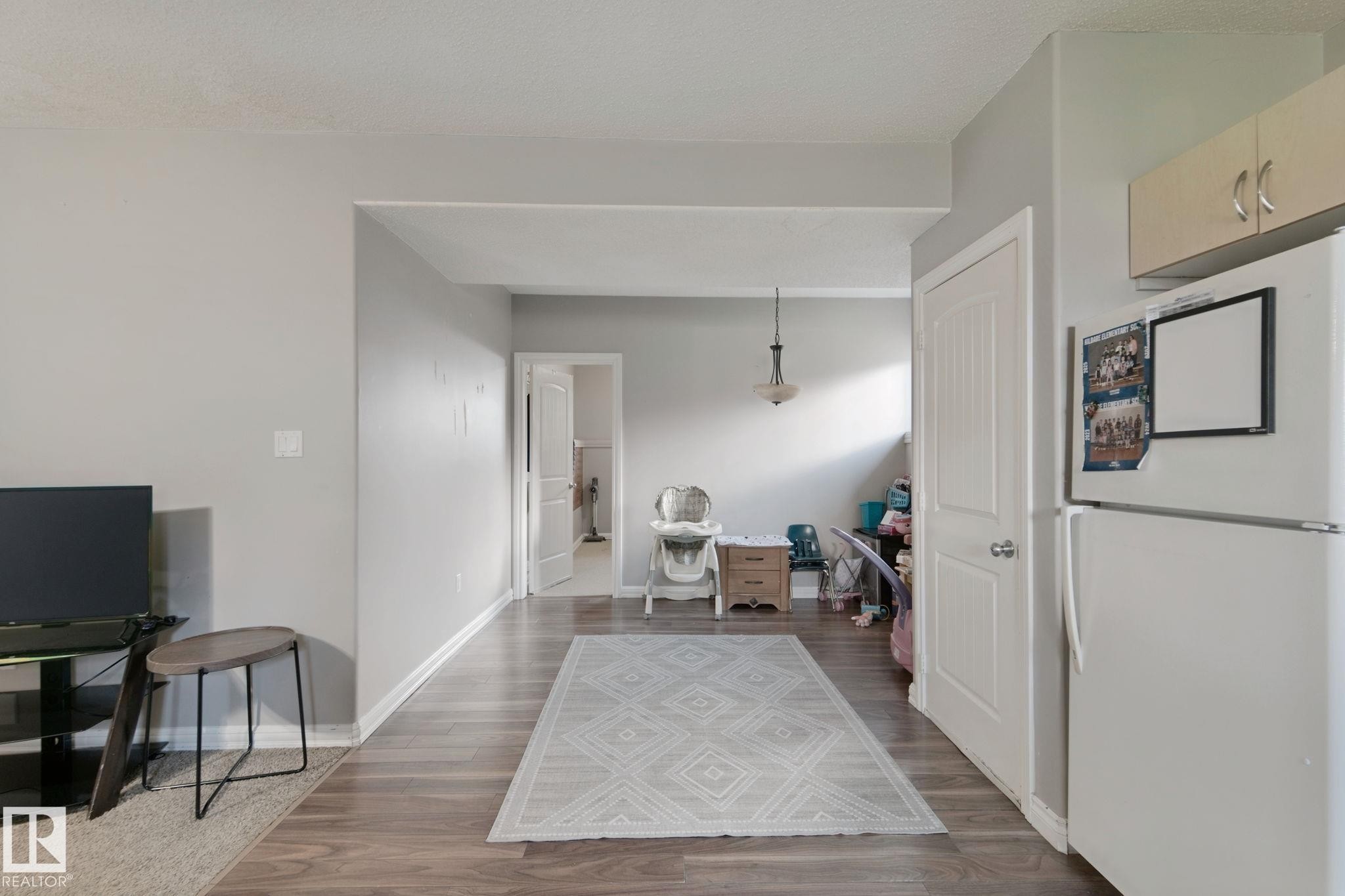 Wood-finish flooring throughout, light gray wall paint, and recessed lighting - 16807 78 Street Nw, Edmonton, AB