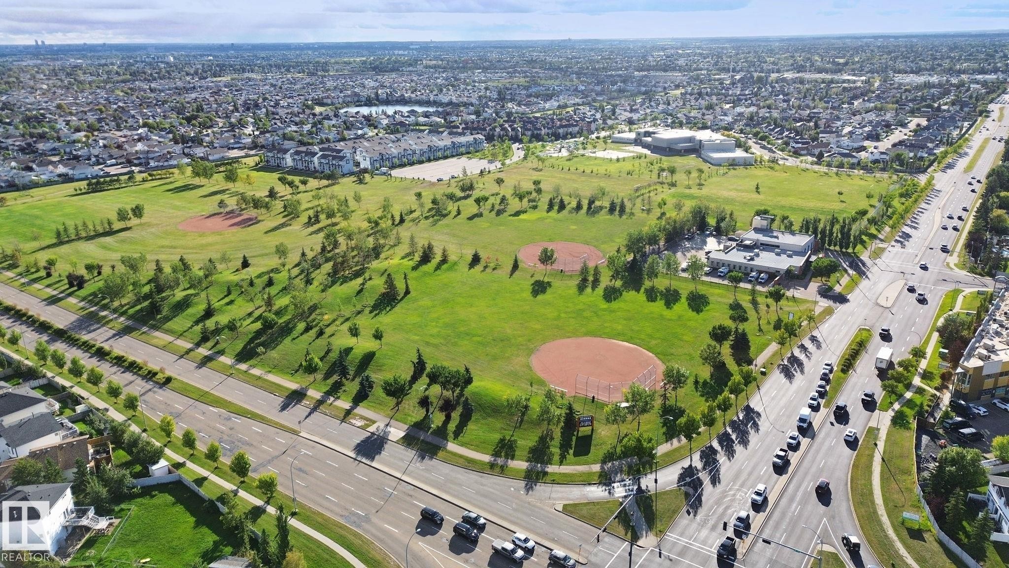 Expansive green spaces with mature trees, two baseball diamonds, and a paved road network - 16807 78 Street Nw, Edmonton, AB