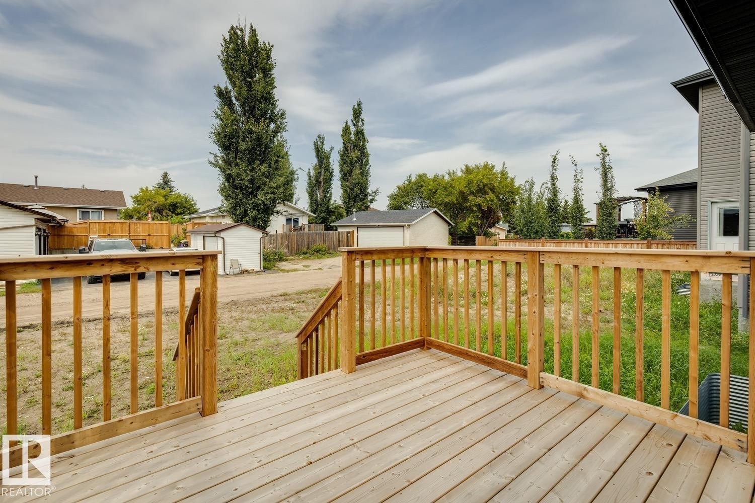 Wooden deck with natural wood railings - 72 Maple Crescent, Gibbons, AB
