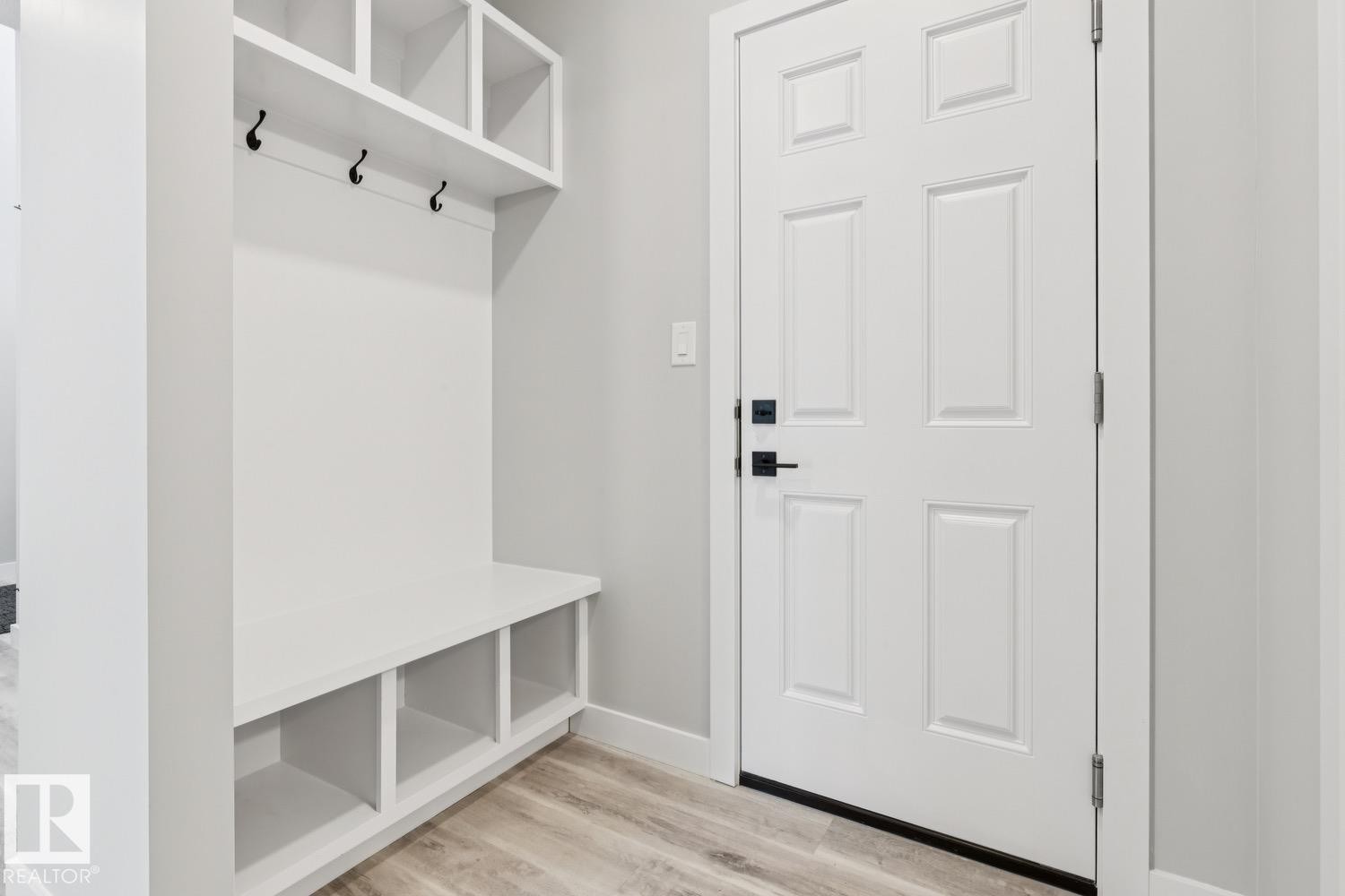 Built-in storage bench with cubbies, upper shelving, and coat hooks - 36 Maple Crescent, Gibbons, AB