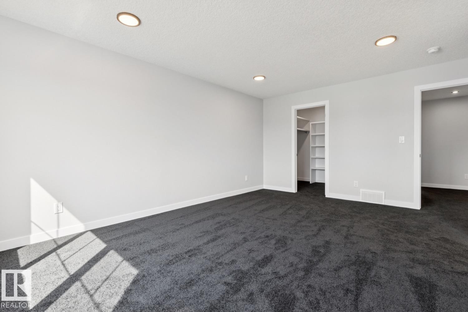 Recessed lighting, wall-to-wall carpeting, built-in closet shelving, and a neutral color palette - 36 Maple Crescent, Gibbons, AB