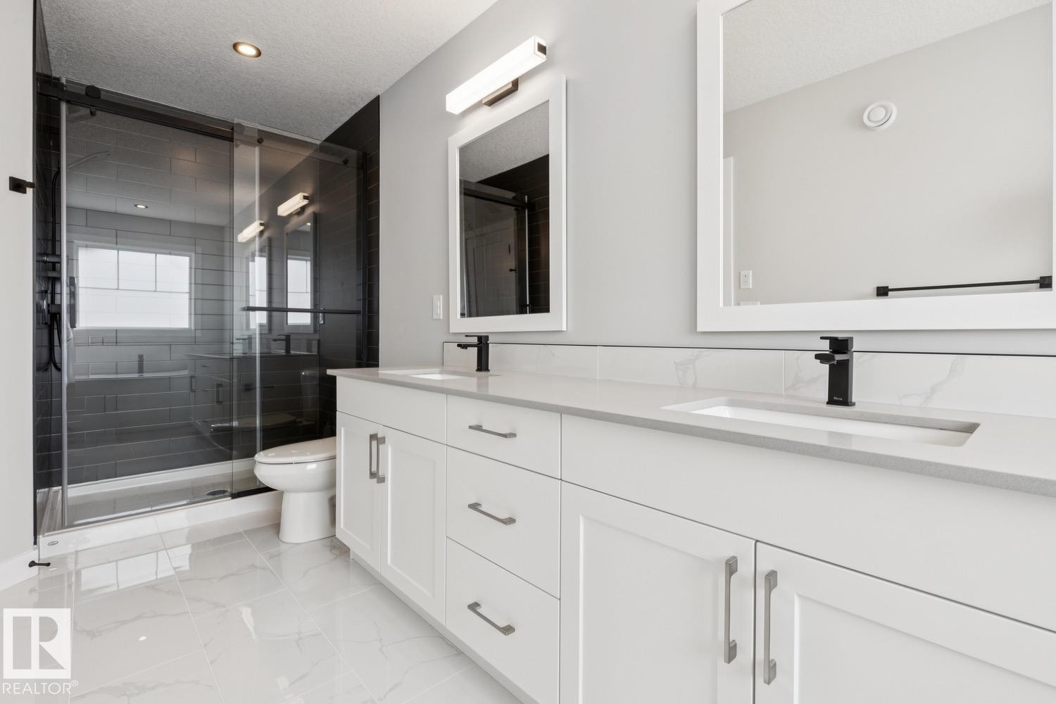 Dual vanity with white cabinetry and integrated sinks - 36 Maple Crescent, Gibbons, AB