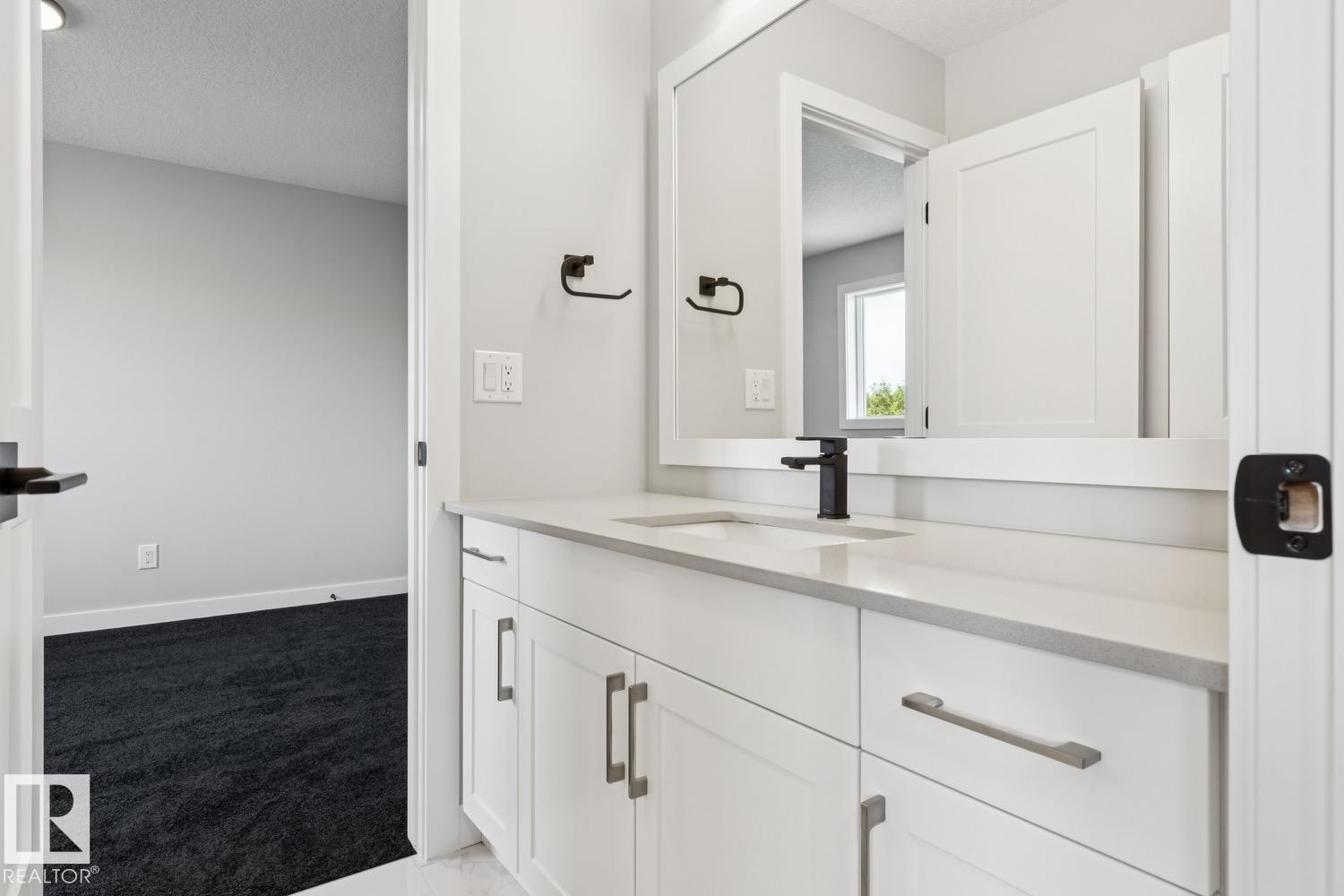 White shaker-style vanity with a light-toned countertop and an integrated sink - 36 Maple Crescent, Gibbons, AB