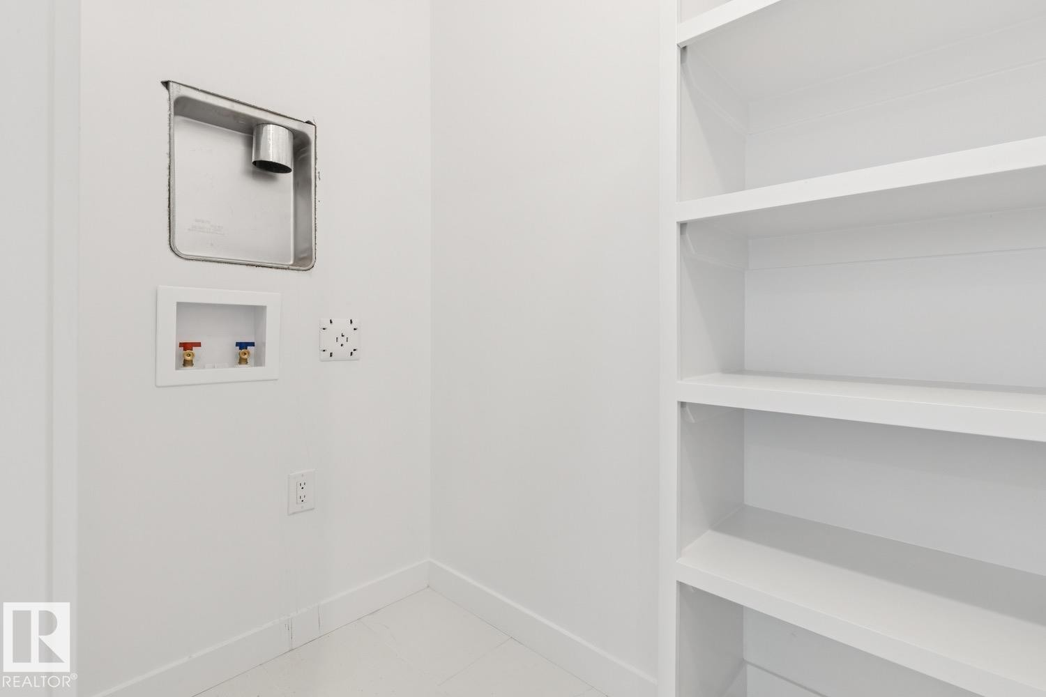 Built-in shelving, white walls, and utility hookups - 36 Maple Crescent, Gibbons, AB